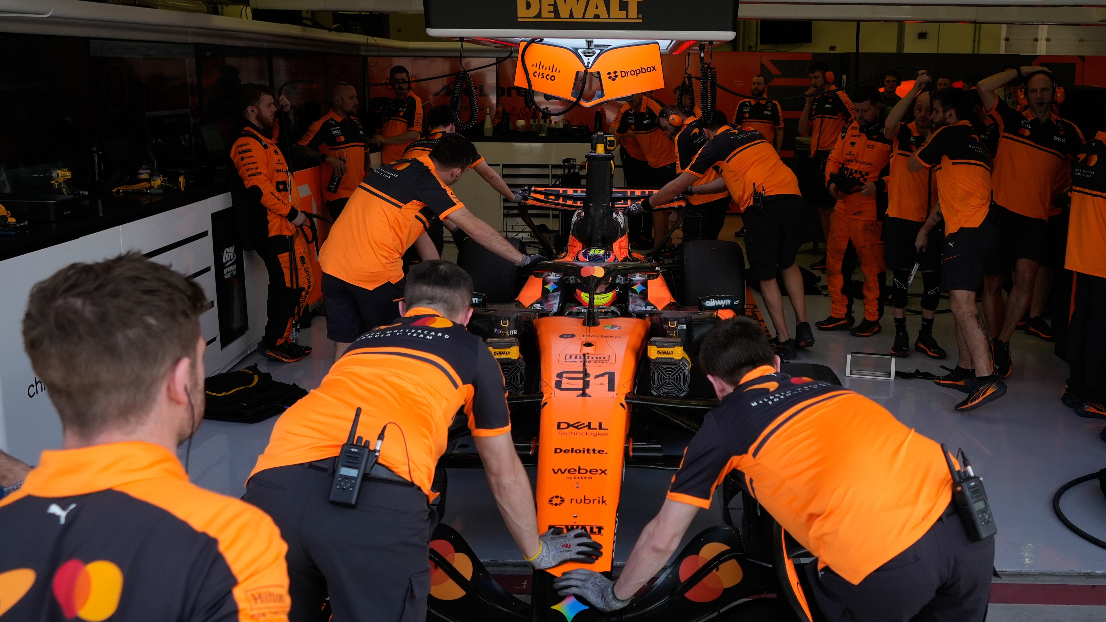 McLaren driver Oscar Piastri of Australia gets pushed back into his garage on the third day of Formula One pre-season test at the Bahrain International Circuit in Sakhir, Bahrain, Friday, Feb. 13, 2026. (AP Photo/Altaf Qadri)