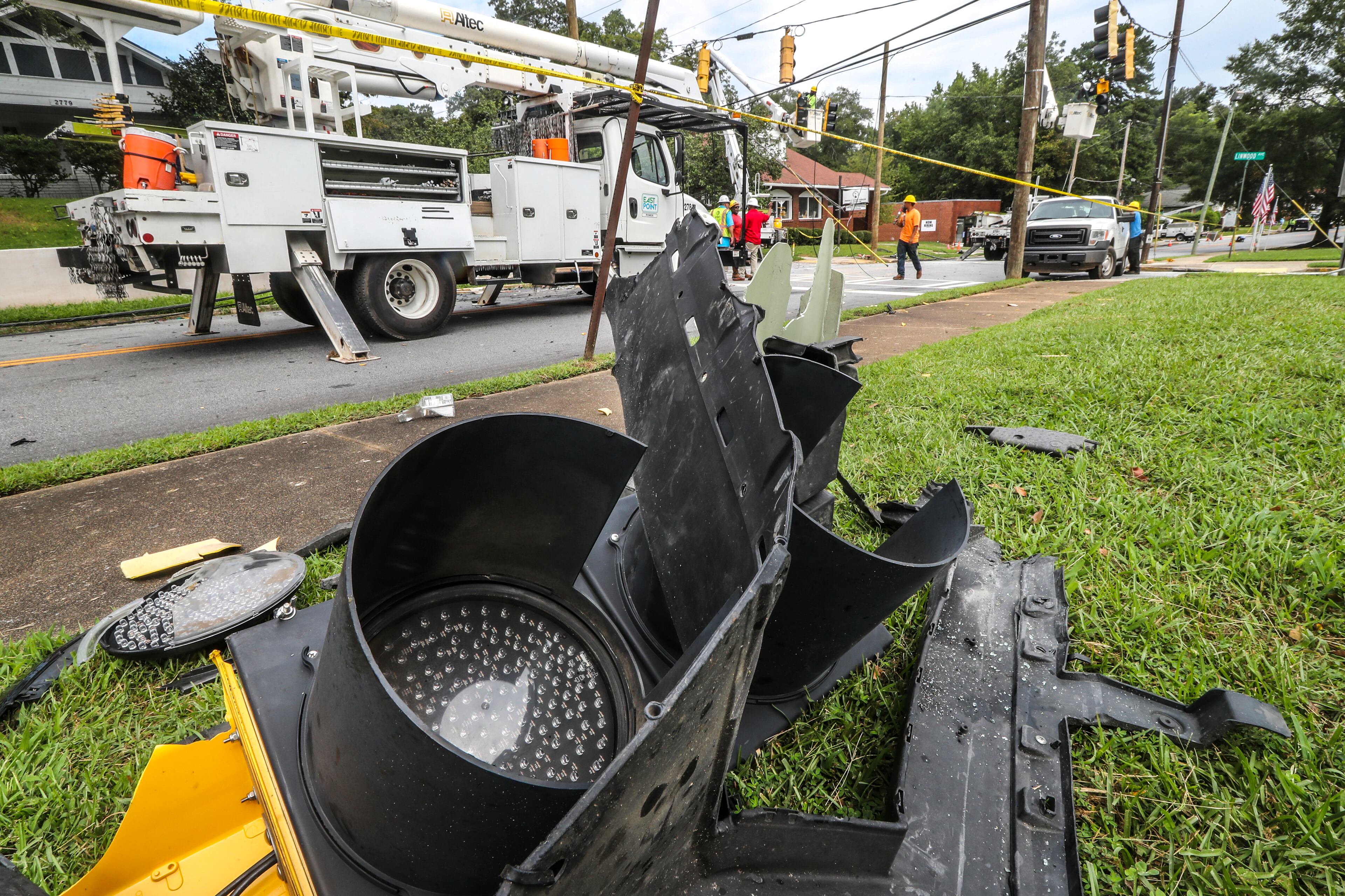 City of East Point utility workers were busy Tuesday replacing poles, downed wires and signal lights at the intersection of Church Street and Linwood Avenue where Morehouse College students Hugh Douglas and Christion Files Jr. died in a car crash Monday. (John Spink / John.Spink@ajc.com)