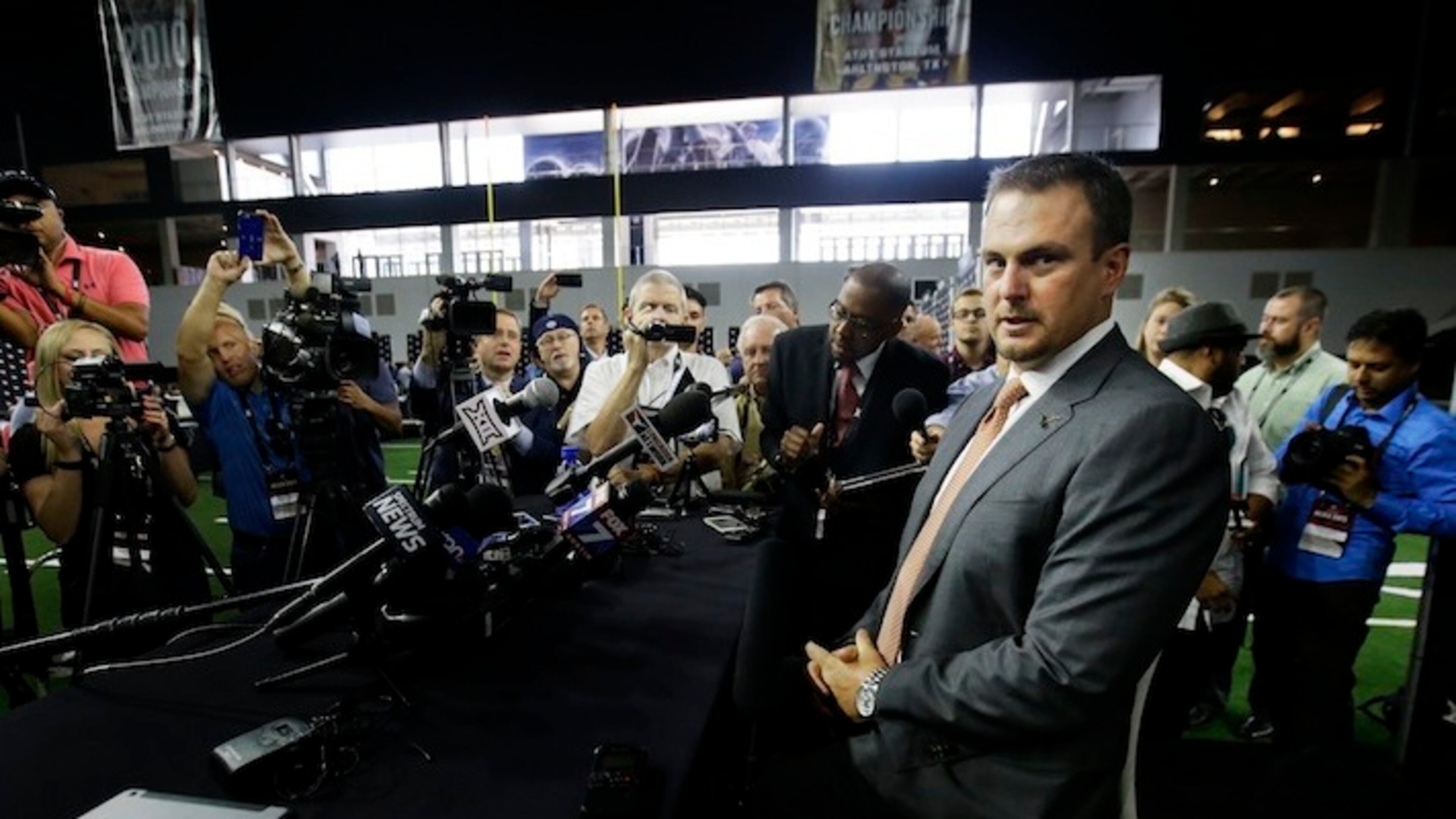 Texas head football coach Tom Herman takes a seat before speaking to reporters during the Big 12 NCAA college football media day in Frisco, Texas, Tuesday, July 18, 2017. (AP Photo/LM Otero)