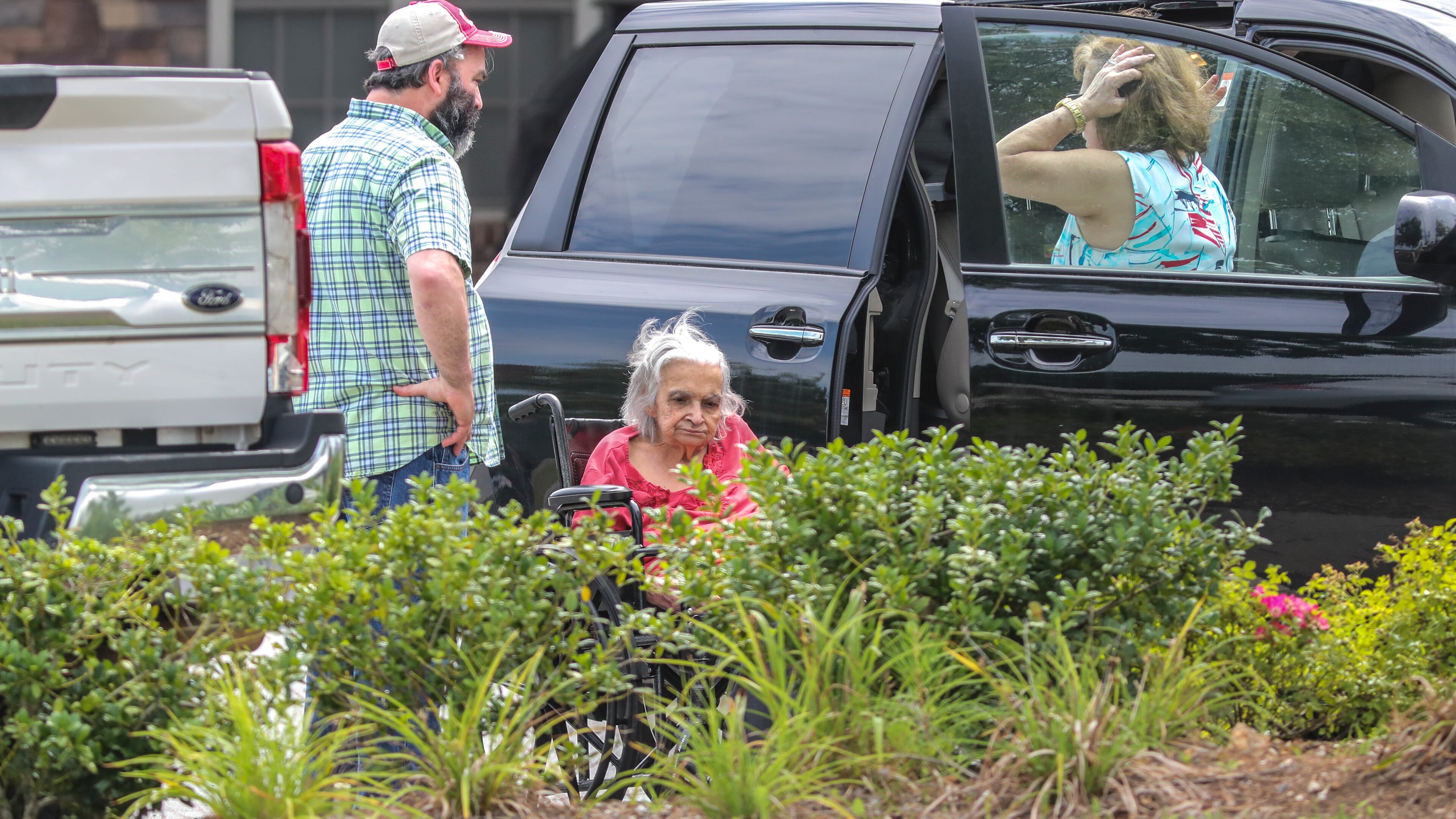 July 16, 2021: Acworth: The last resident to leave the facility is helped into a vehicle as all residents were to have been moved out of Tranquil Gardens Assisted Living and Memory Care in Acworth by Noon on Friday, July 16, 2021 after owners informed residents and workers they were foreclosed. Tranquil Gardens Assisted Living and Memory Care informed their residents on Tuesday that the property was being foreclosed on and they would need to move out by Friday. (John Spink / John.Spink@ajc.com)