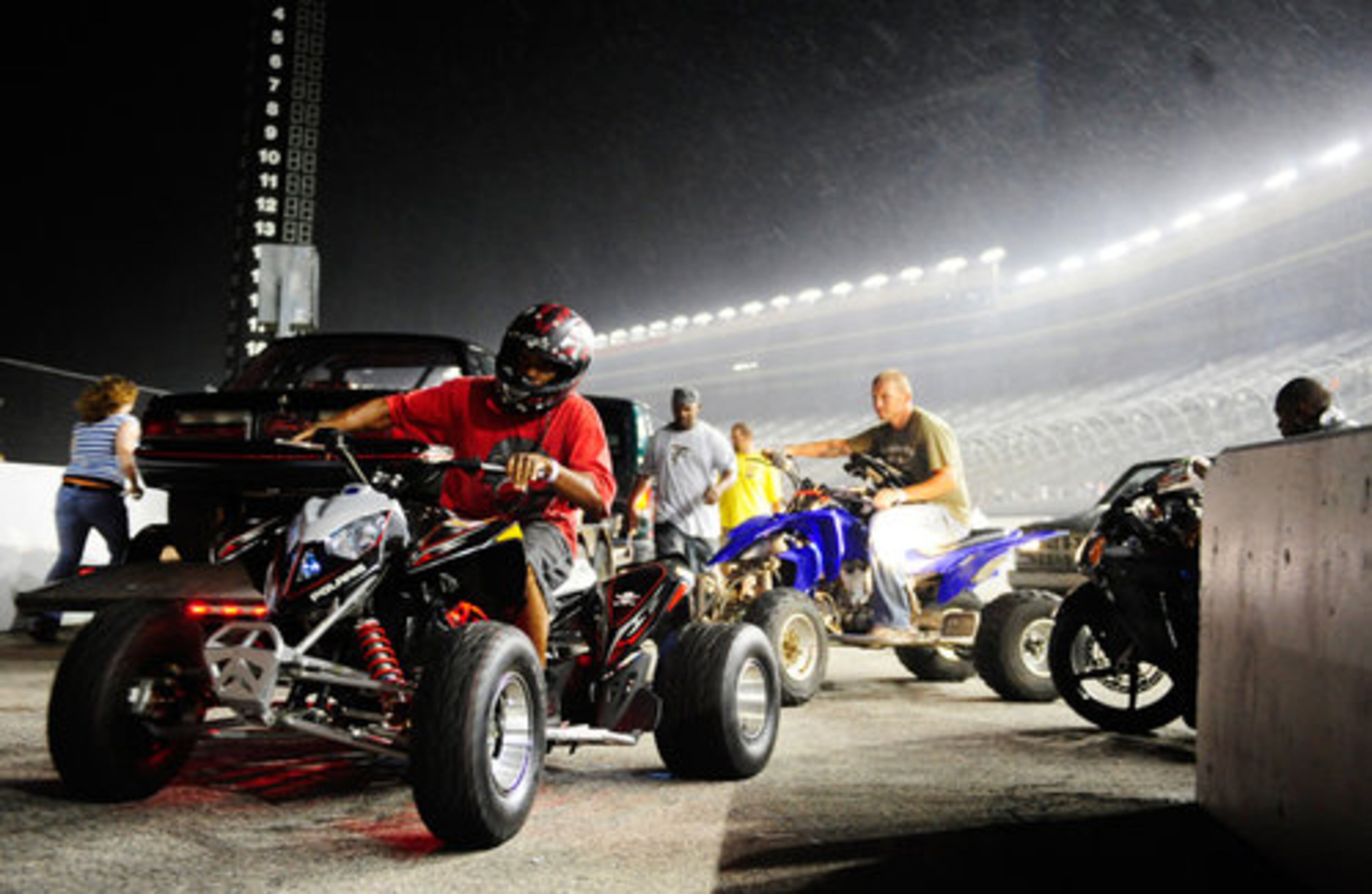 Drivers steer their vehicles off the Atlanta Motor Speedway track after a thunderstorm rolls over during Fastlife Friday in Hampton, Ga. Fastlife Fridays is a new summer monthly event at the Atlanta Motor Speedway, featuring celebrity performances and races between anyone with a Georgia drivers license and a working vehicle. The next Fastlife Friday is Aug. 13.