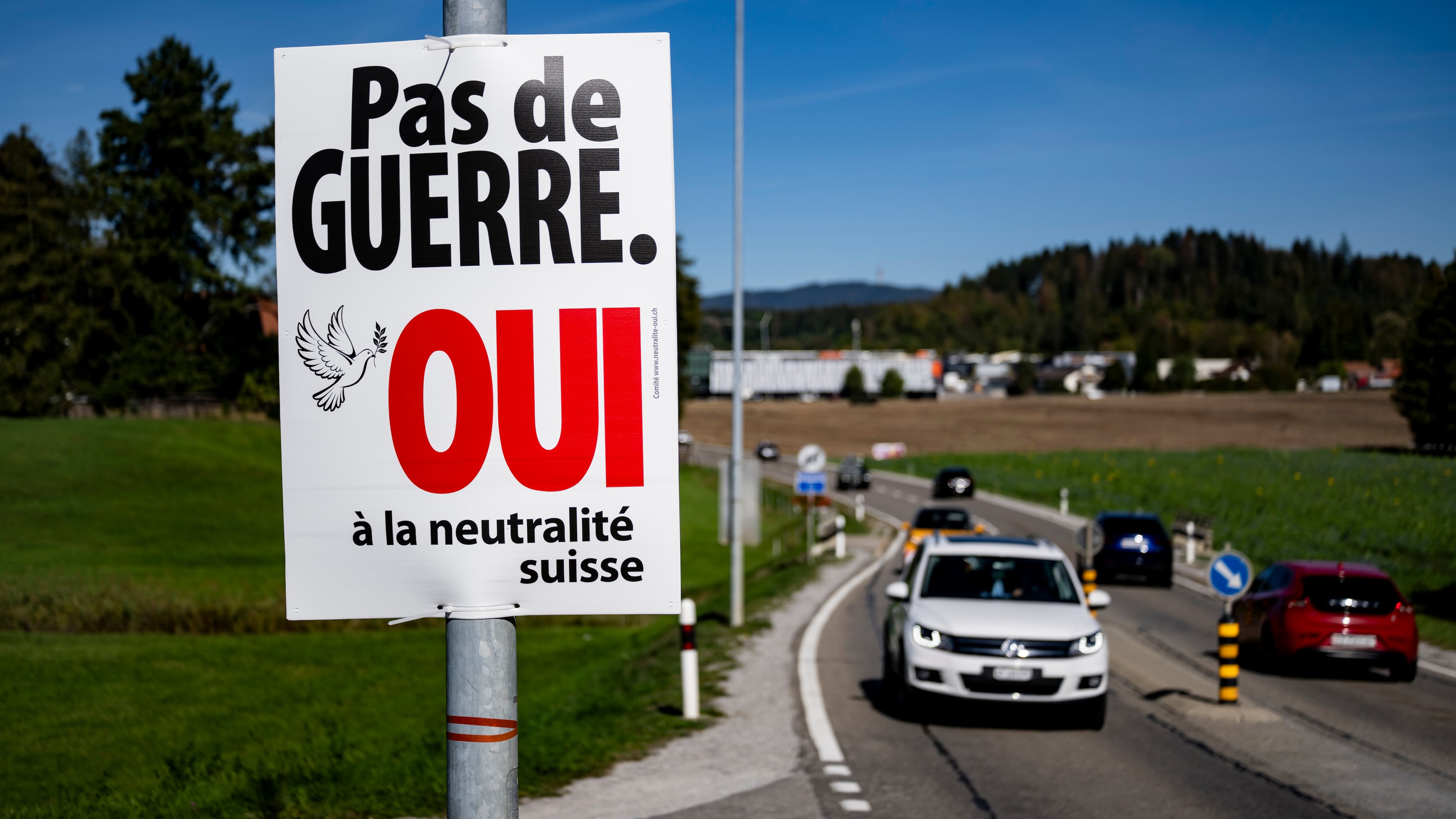 An electoral poster reads "No war, Yes to Swiss neutrality" is posted along a road in Epagny, Switzerland, Friday, Sept. 25, 2026. (Jean-Christophe Bott/Keystone via AP)