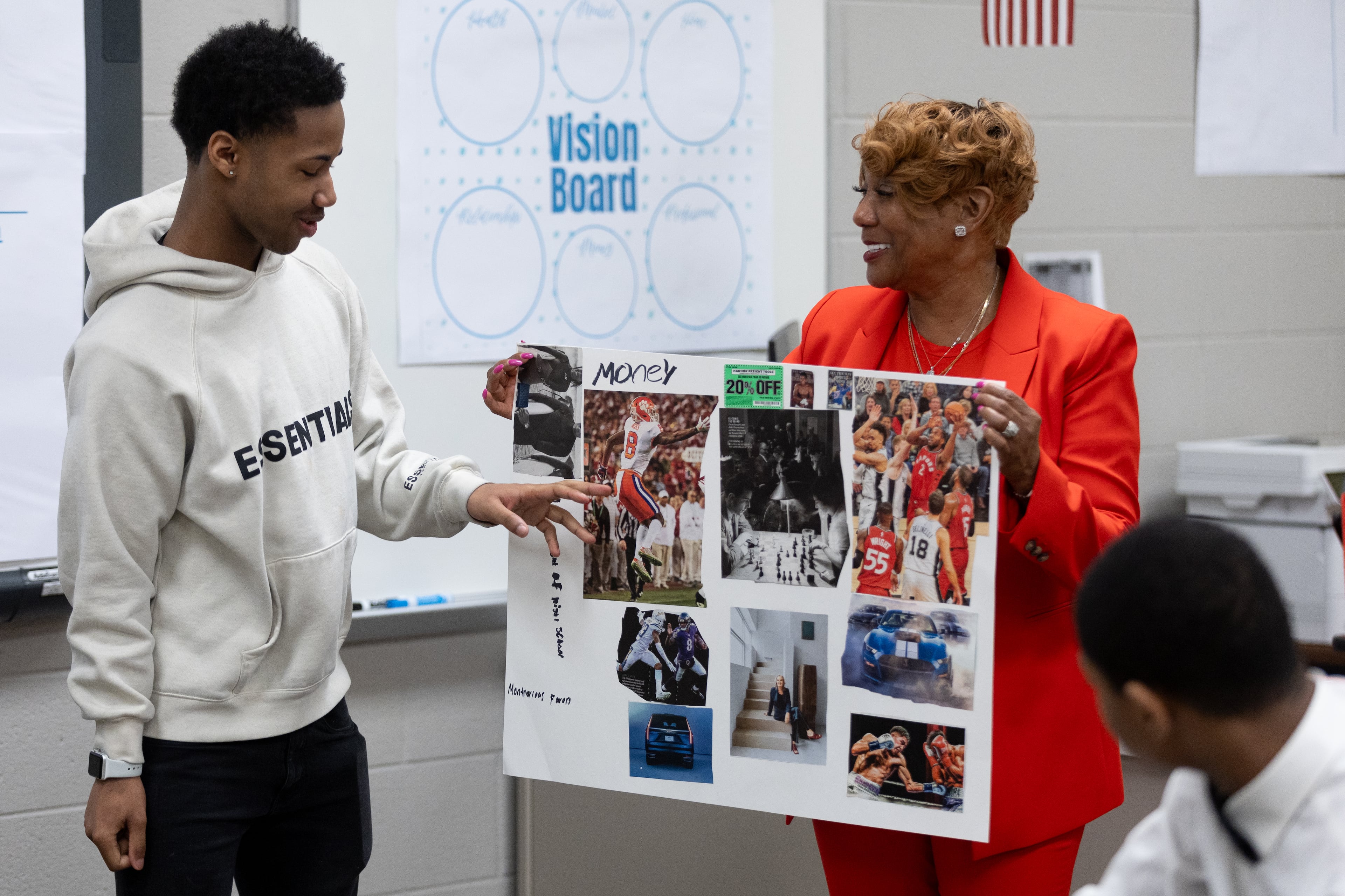 Redan High School FACE advocate Melinda Adams holds Montravious Favors' vision board during a class presentation following an end-of-year group project in Stone Mountain on Tuesday, May 14, 2024. The DeKalb County School District has placed one-on-one mentors at some schools this year to help improve students' attendance, behavior and academic performance. (Steve Schaefer / AJC)