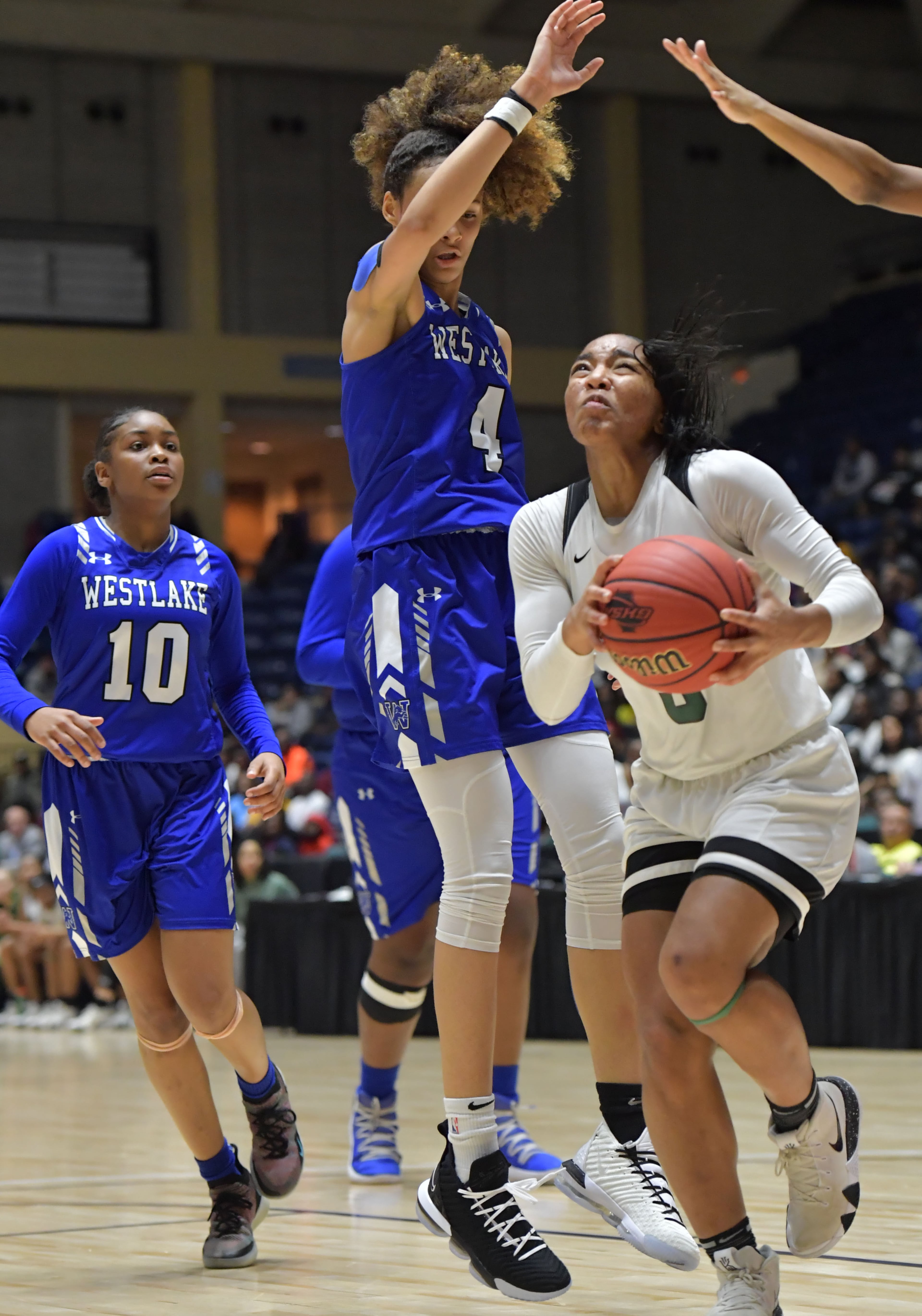 March 9, 2019 Macon - Collins Hill Jordan Releford (5) goes to the basket past Westlake Brianna Turnage (4) in GHSA State Basketball Championship game at the Macon Centreplex in Macon on Saturday, March 9, 2019. HYOSUB SHIN / HSHIN@AJC.COM