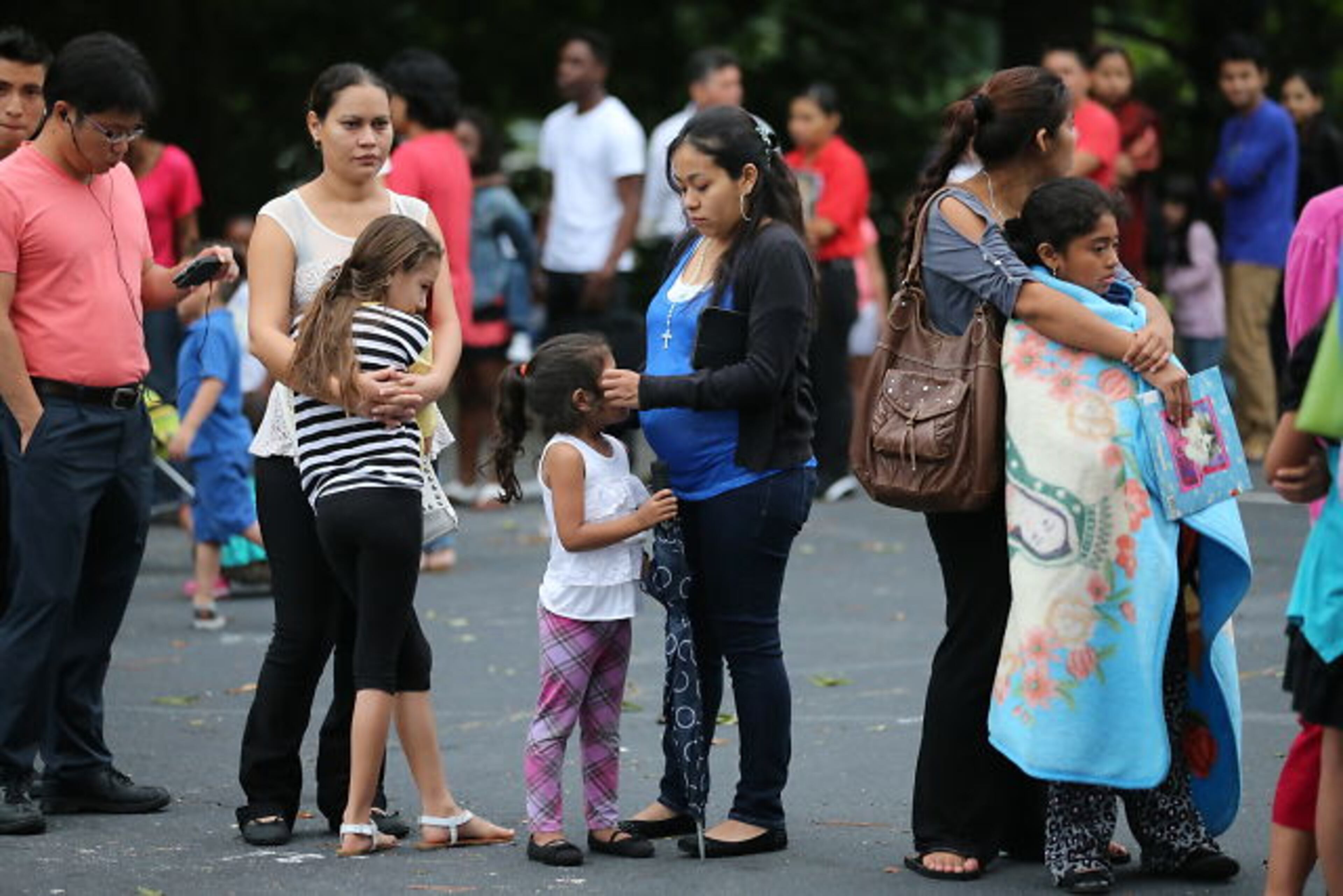 Hoping to get their children enrolled in DeKalb County Schools, immigrant families spent Thursday night and early Friday lined up with their children outside district headquarters.