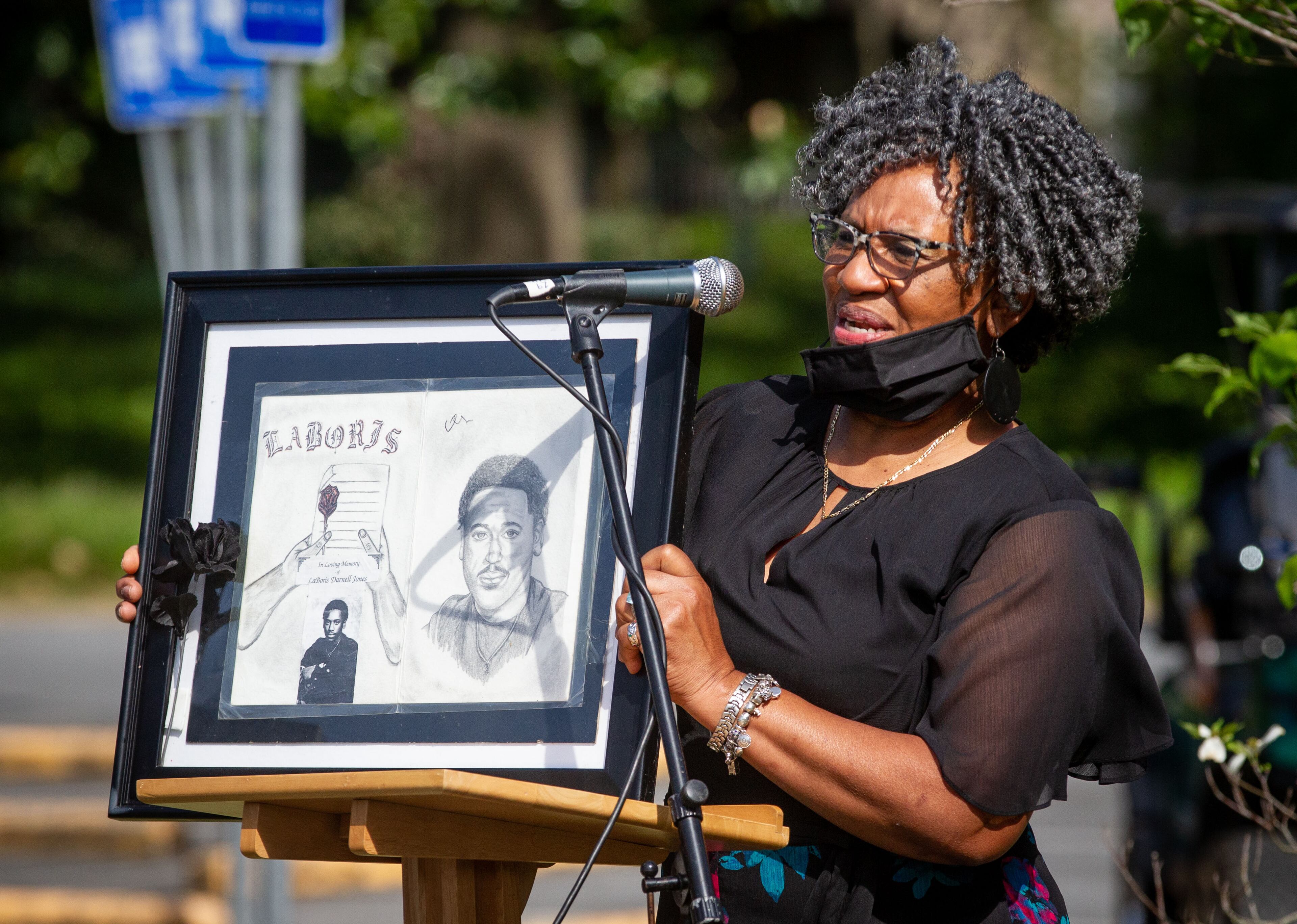D'Borah Jones-Green holds up a drawing of her son, who was killed in 1996, during the 31st Annual Crime Victims' Memorial Service at the First Baptist Church of Decatur on Sunday, April 18, 2021. (Photo: Steve Schaefer for The Atlanta Journal-Constitution)