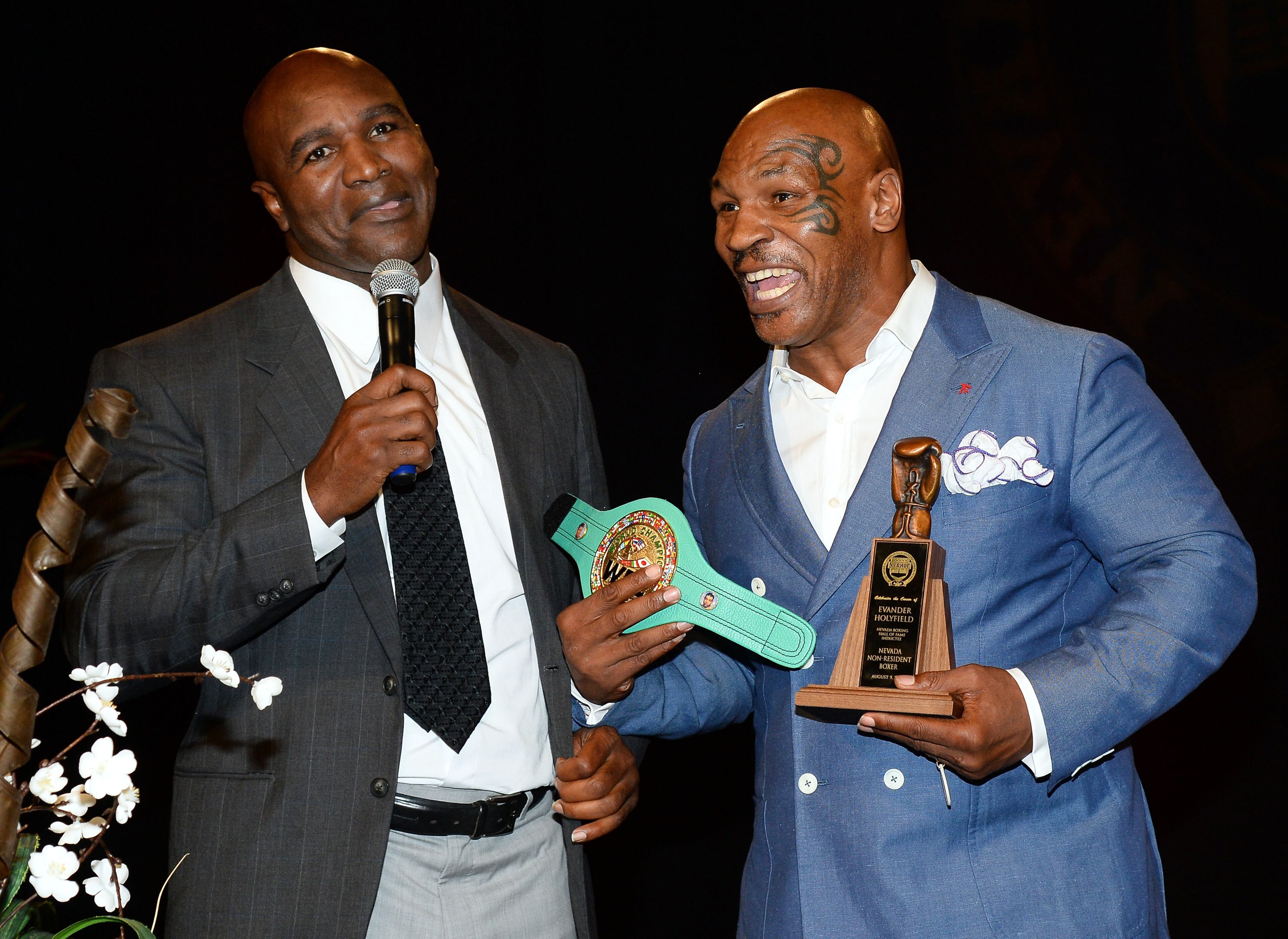 LAS VEGAS, NV - AUGUST 09: Former boxer Evander Holyfield (L) jokes around with former boxer Mike Tyson as he inducts Holyfield into the Nevada Boxing Hall of Fame at the second annual induction gala at the New Tropicana Las Vegas on August 9, 2014 in Las Vegas, Nevada. (Photo by Ethan Miller/Getty Images)