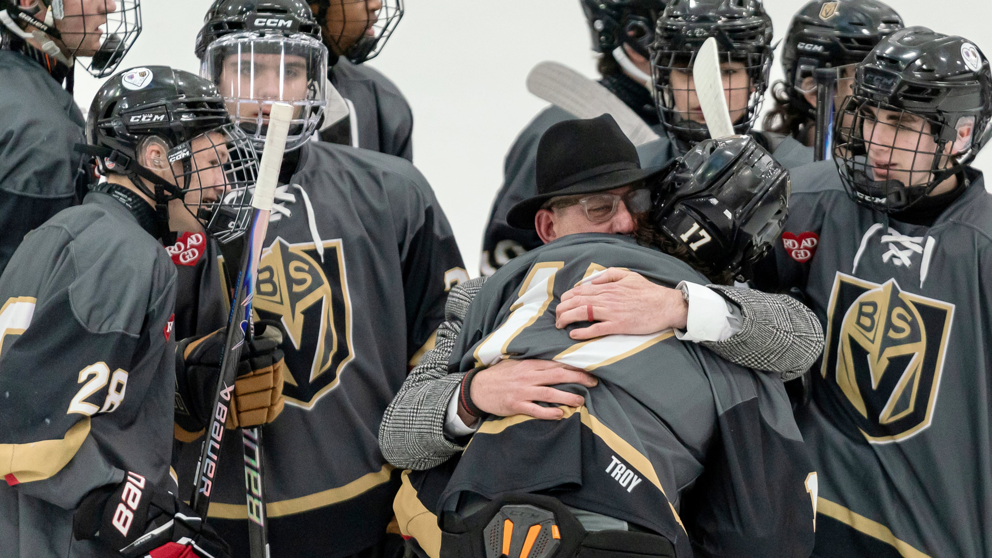 Blackstone Valley Schools head coach Chris Librizzi embraces Colin Dorgan after Dorgan scored the double-overtime game-winning goal against Portsmouth High School in the Rhode Island high school hockey state semifinal, Wednesday, March 11, 2026, at Schneider Arena on the campus of Providence College in Providence, R.I. (Courtesy of T.J. Auclair & Kyle Auclair/Little Big Leaguers Photography via AP)
