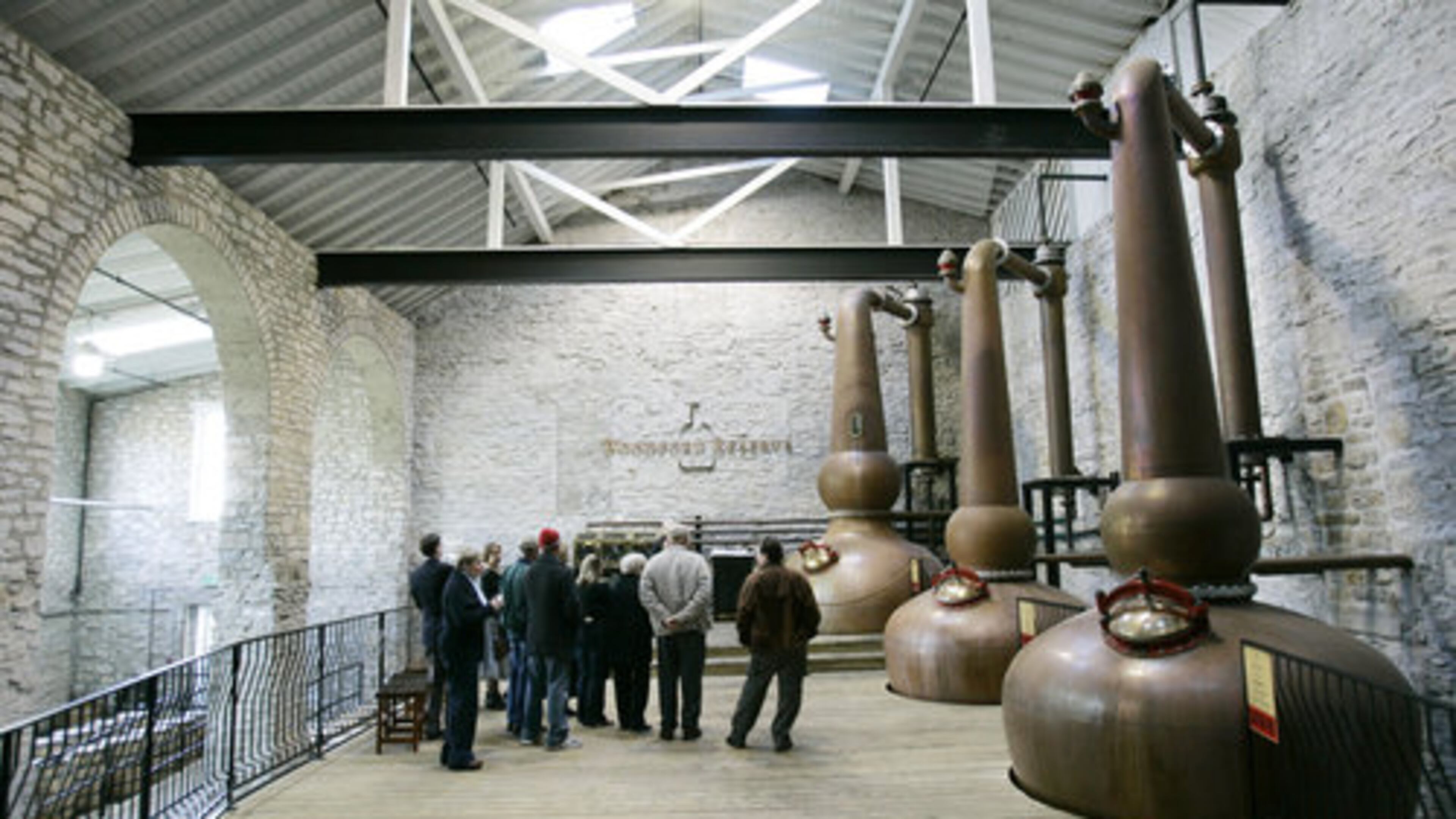 A tour group looks over the copper stills at the Woodford Reserve distillery.