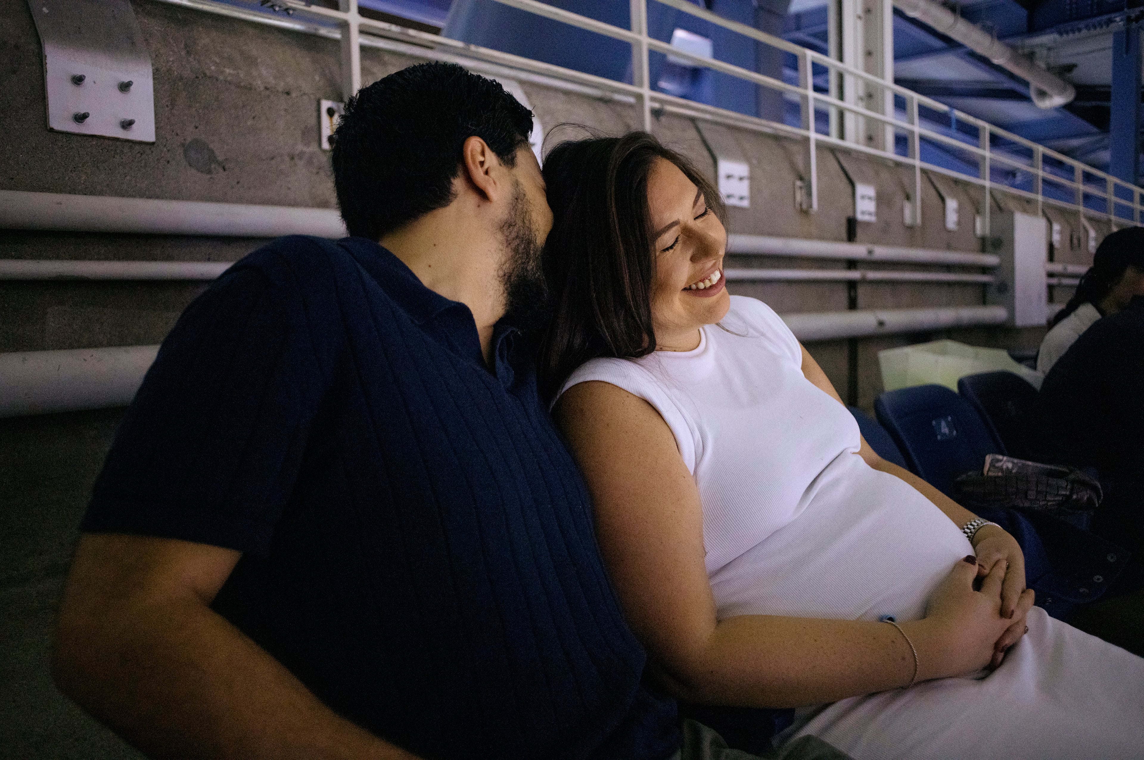 Matthew Shalhoub, left, and Jennifer Shalhoub sit in Row Z a couple days before their babyÕs due date, during the U.S. Open tennis tournament, at Arthur Ashe Stadium in Queens, on Aug. 30, 2024. (Jos A. Alvarado Jr./The New York Times)