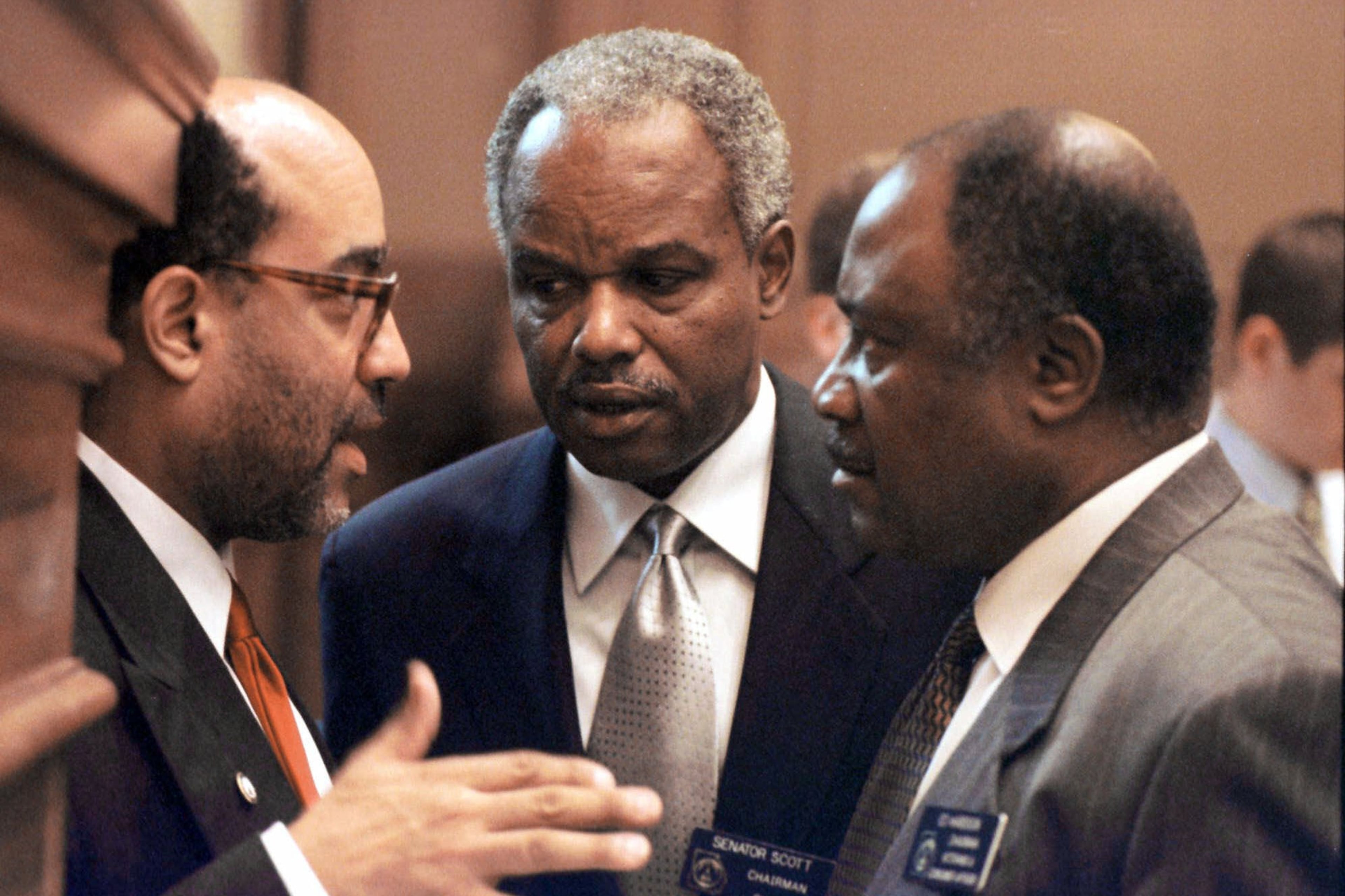 Georgia Congressman David Scott (center) confers with fellow lawmakers at the state Capitol in 2000. (Alan Mothner/AP)