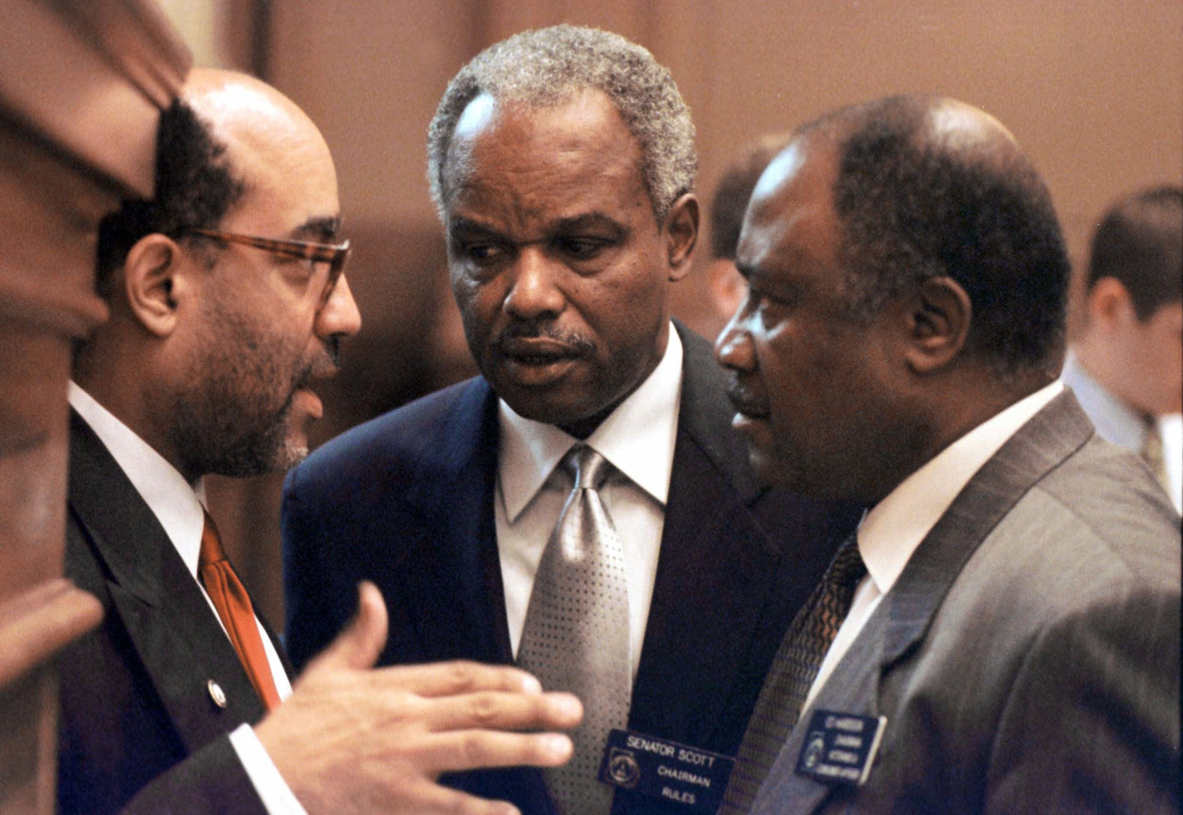(From left) Sen. Vincent Fort, D-Atlanta, Sen. David Scott, D-Atlanta, and Sen. Ed Harbison, D-Columbus, confer in the state Senate in Atlanta on Monday, March 6, 2000. (Alan Mothner/AP)