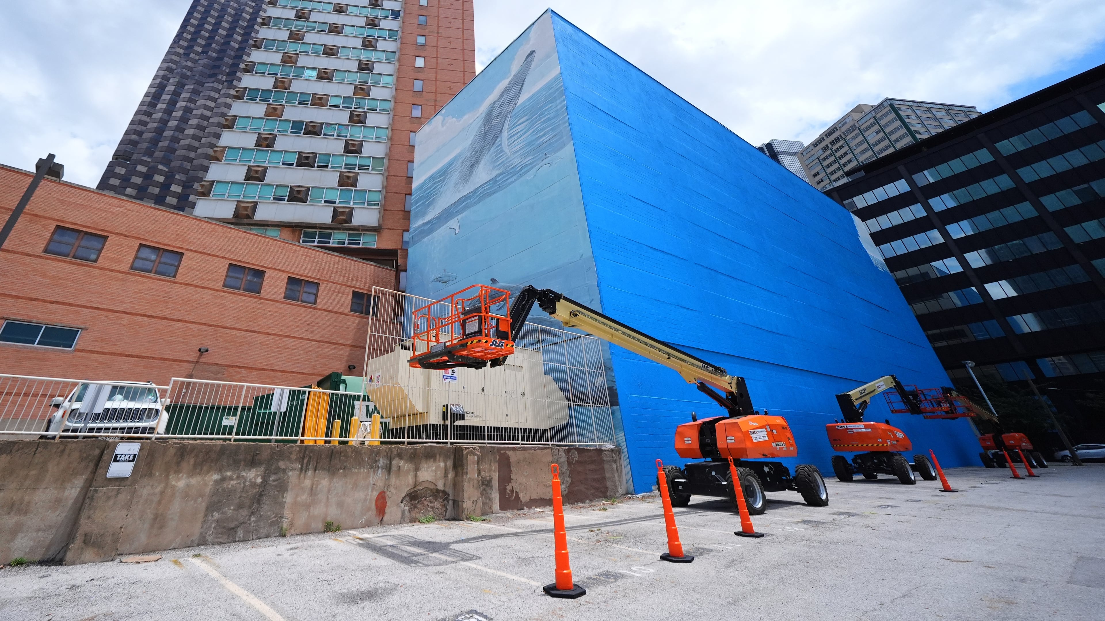 A section of a mural, known as the "Whaling Wall 82," created by artist Wyland, is visible as part of it on the right side of the building was painted over, Monday, May 18, 2026, in Dallas. (AP Photo/Julio Cortez)