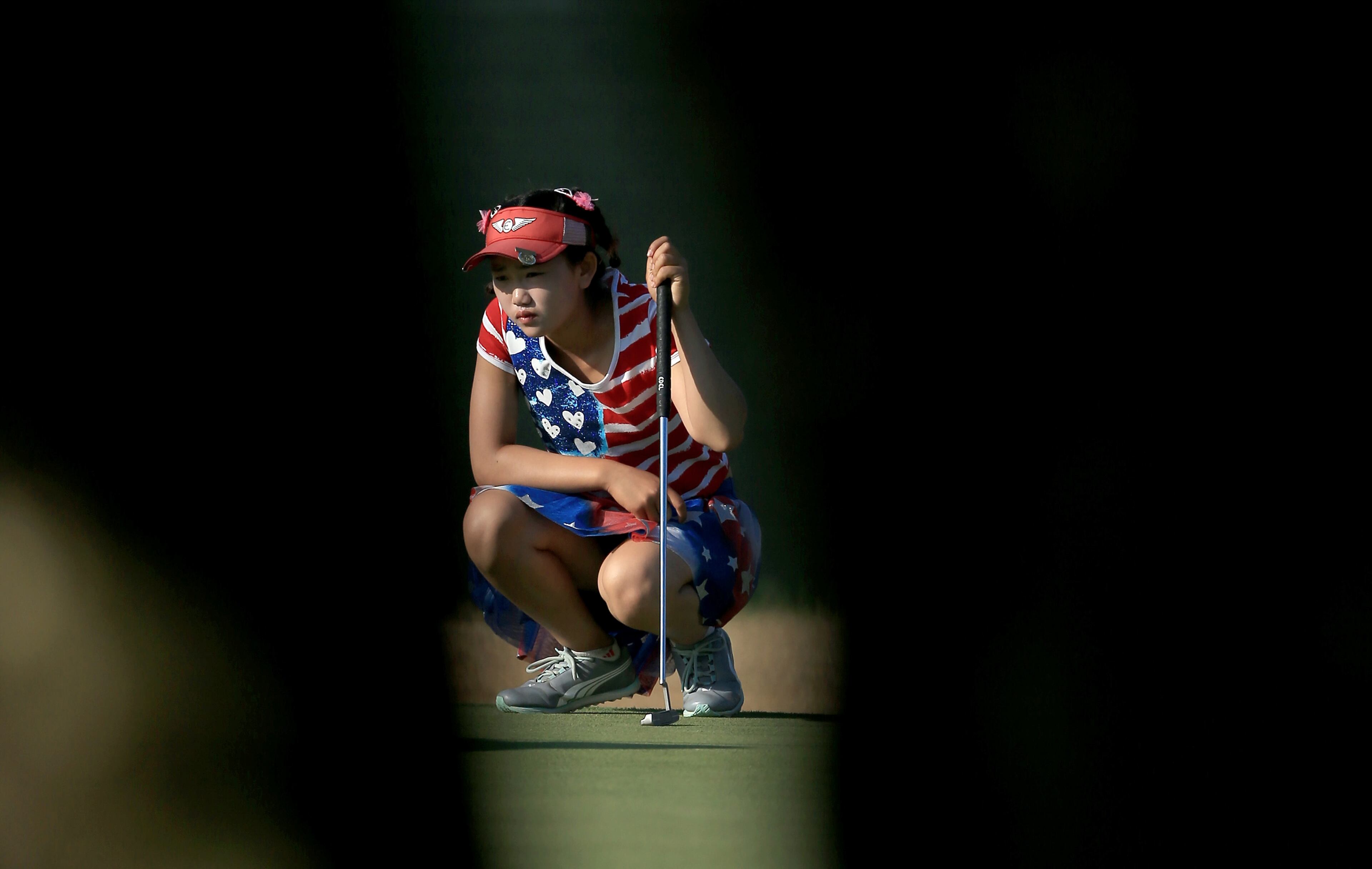 Lucy Li of the USA, who is only 11 years old, lines up a putt at the par 4, 14th hole during the first round of the 69th U.S. Women's Open at Pinehurst Resort & Country Club, Course No. 2 on June 19, 2014 in Pinehurst, North Carolina. (Photo by David Cannon/Getty Images)