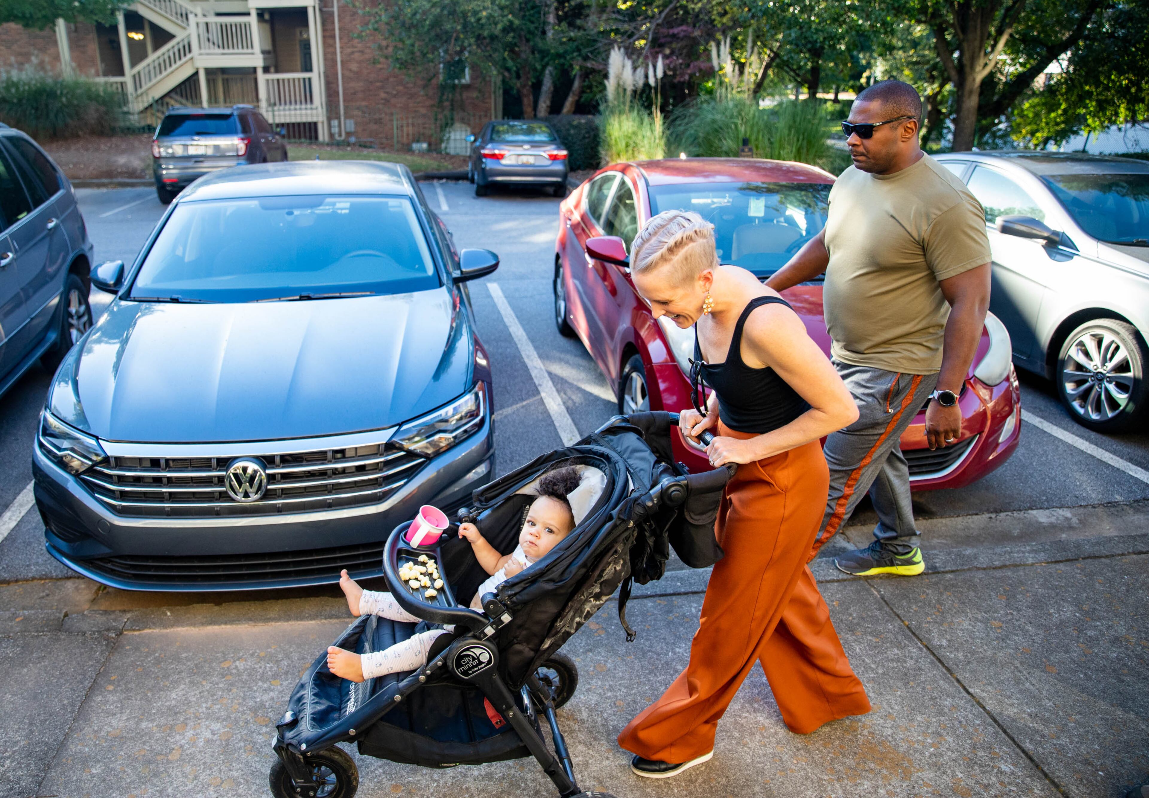 Akil Sanders, right, with his wife, Stefanie, and their daughter, Nola, walking in their Old Fourth Ward neighborhood. Sanders said: “Atlanta is growing, growing, growing and I want my property value to continually be worth something and I want my kids to be able to go schools in nice places. And I want my friends’ kids to be able to go to schools in nice places and feel safe.” (Jenni Girtman for The Atlanta Journal-Constitution)