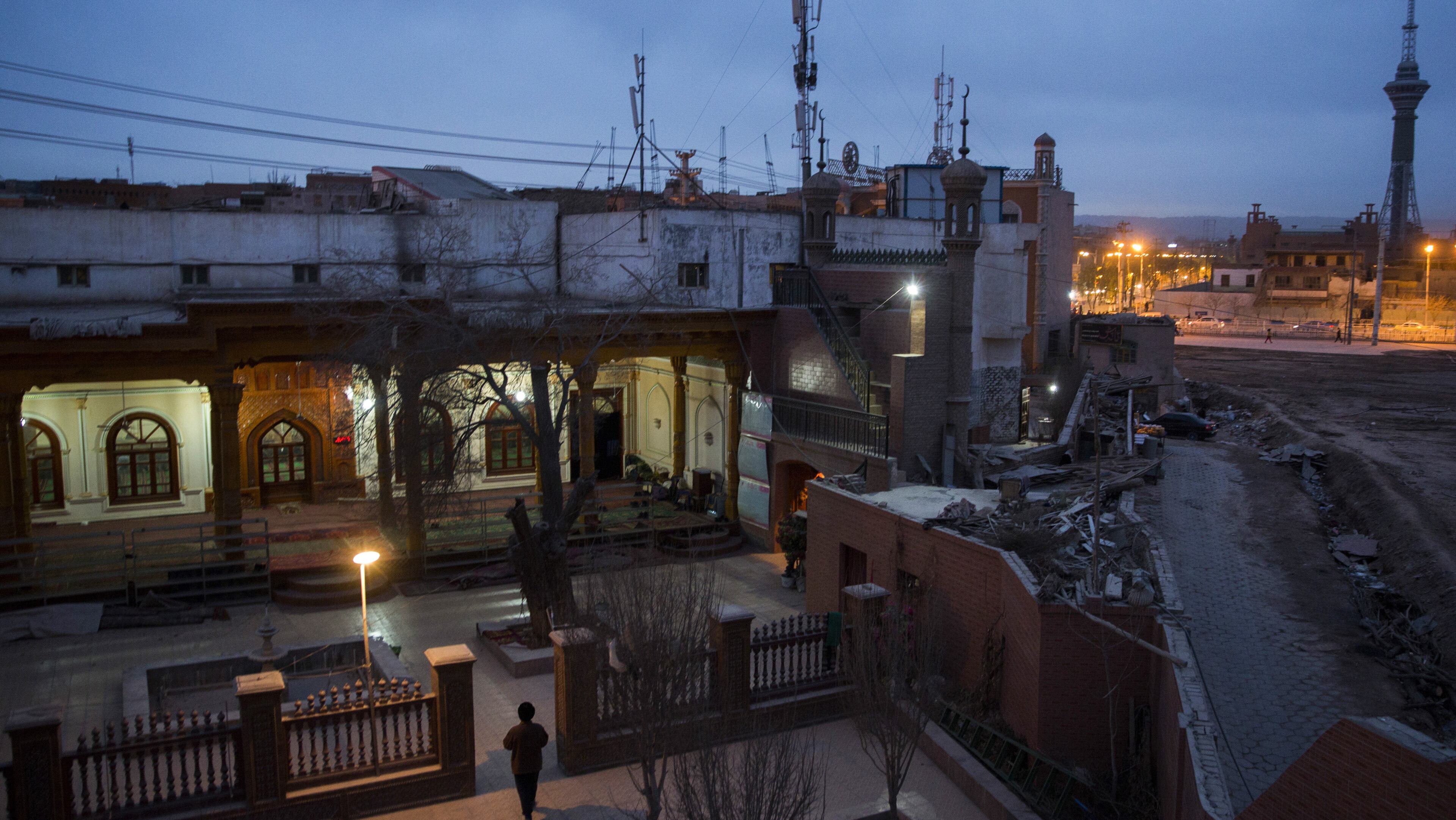 A Uighur man walks into a mosque for evening prayer in Kashgar, in China’s far western province of Xinjiang. (Adam Dean/The New York Times)