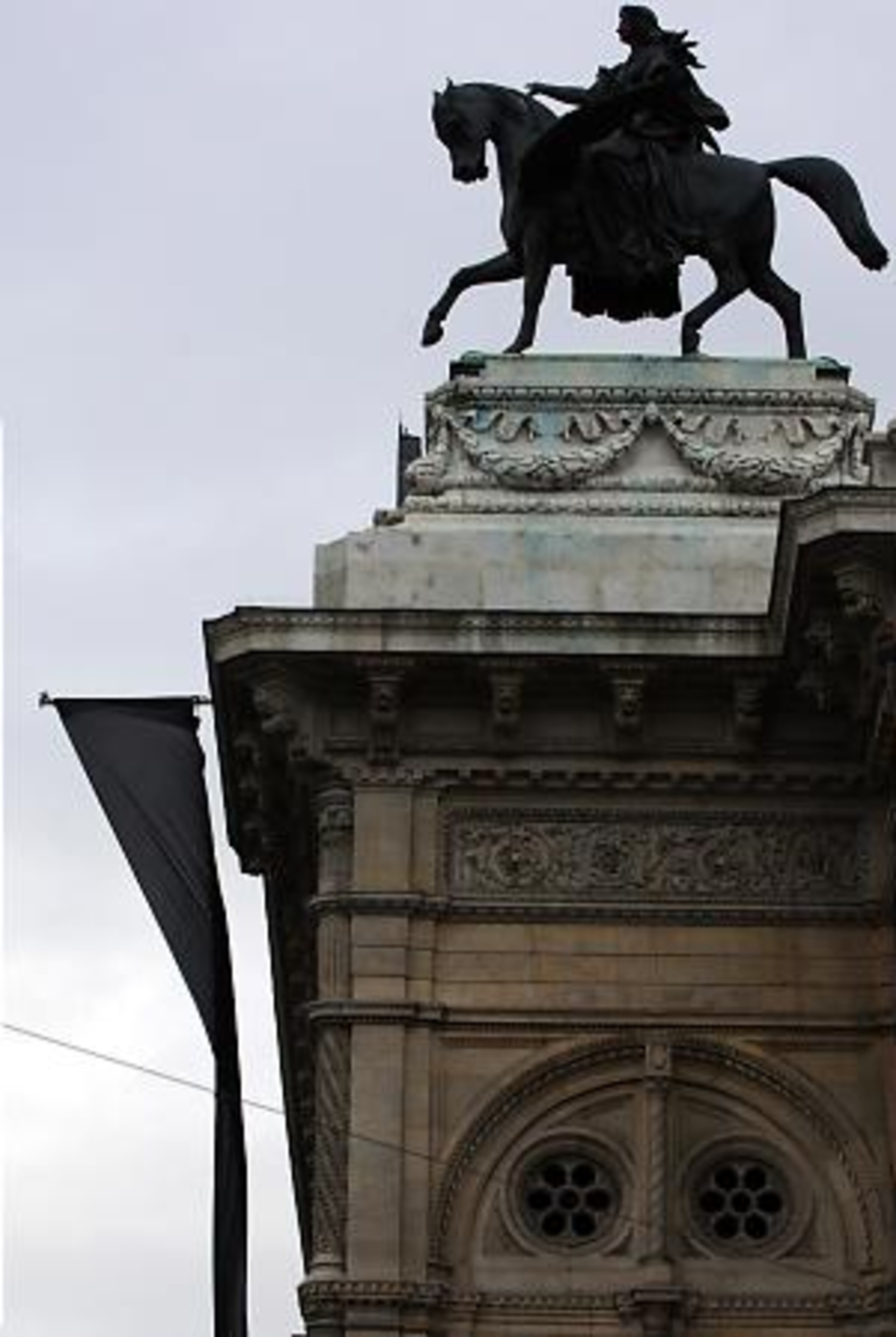 A huge black flag flies on the building of the world famous Opera House of Vienna, Austria to commemorate Luciano Pavarotti.