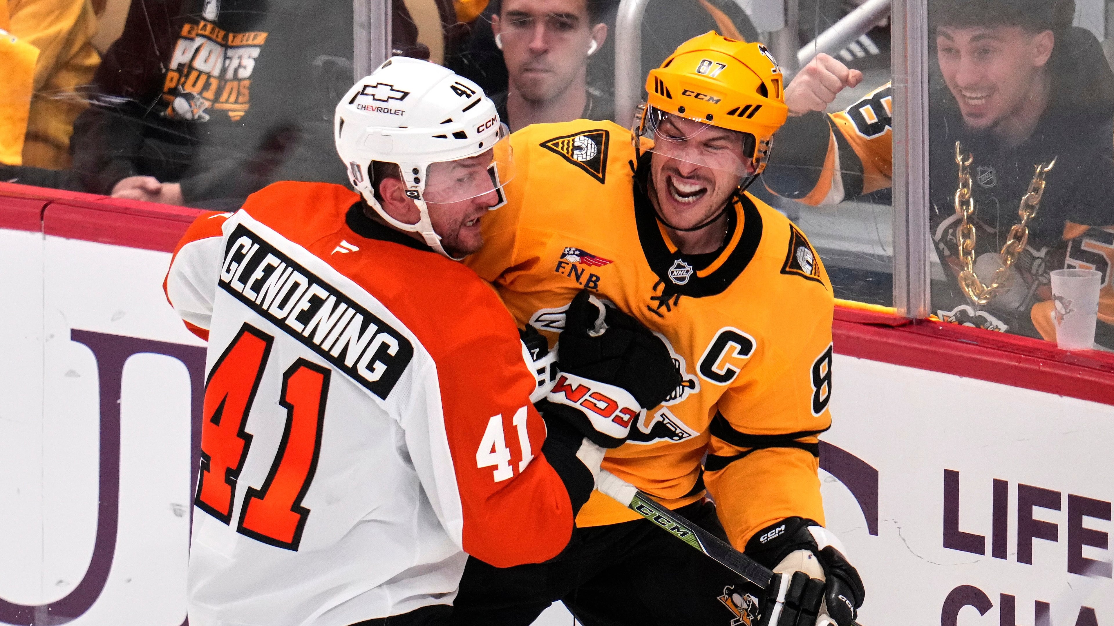 Pittsburgh Penguins' Sidney Crosby, right, is defended by Philadelphia Flyers' Luke Glendening (41) during the third period of Game 5 in the first round of an NHL hockey Stanley Cup playoff series in Pittsburgh, Monday, April 27, 2026. (AP Photo/Gene J. Puskar)