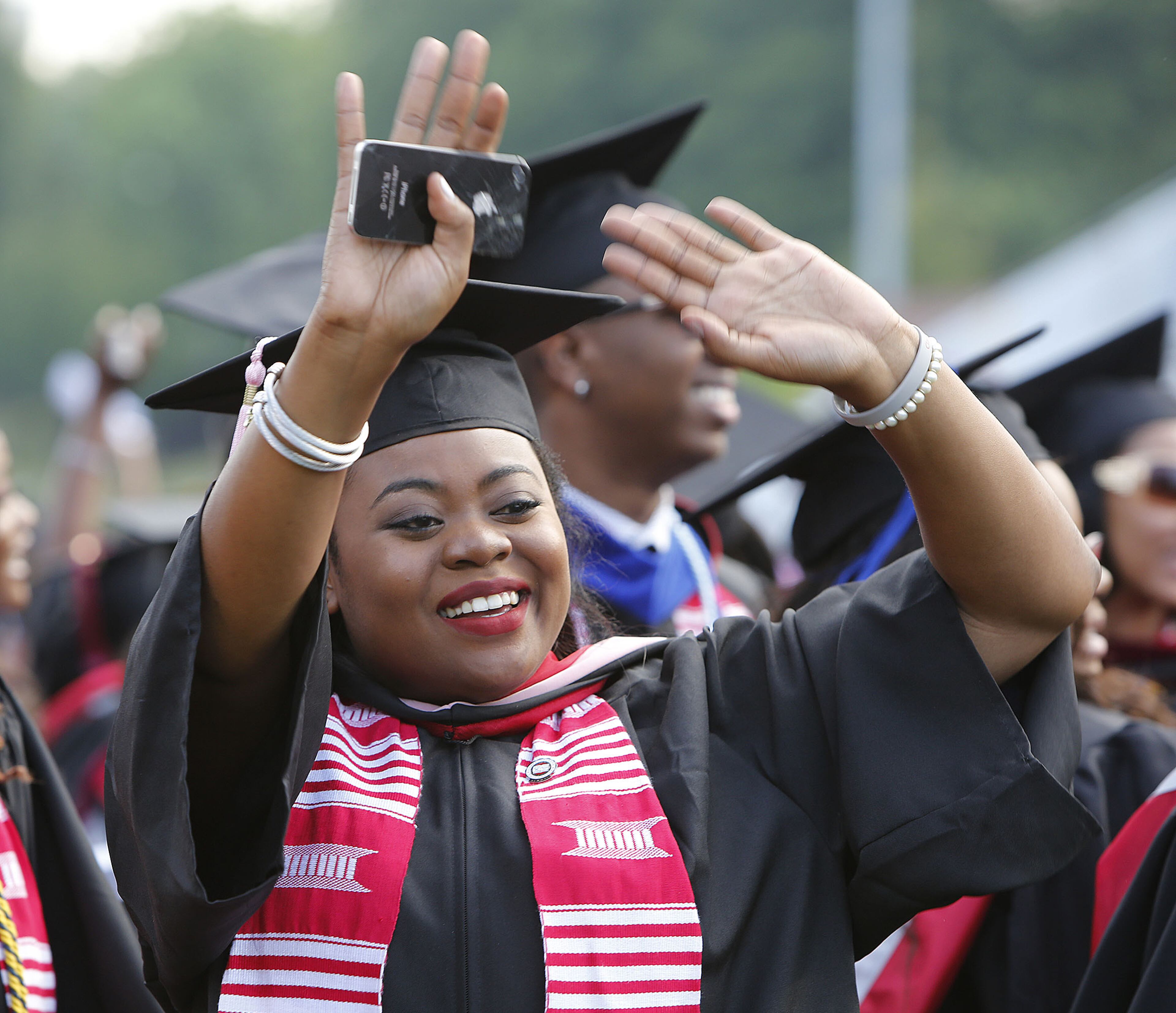 Clark Atlanta University student Sacha Hall waved to her family during a break in graduation ceremonies in Atlanta on Monday May 18, 2015. (Photo by Phil Skinner)