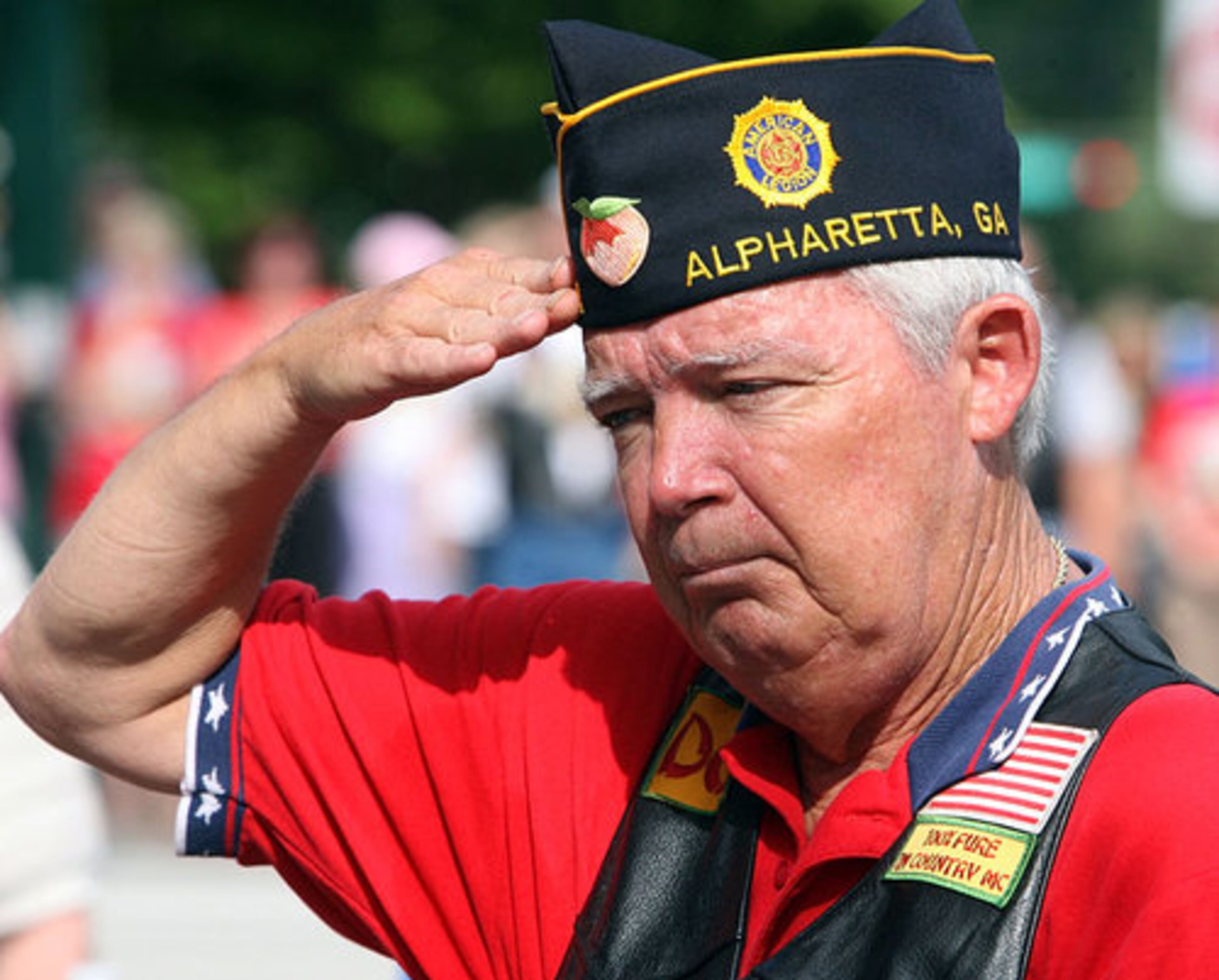 Post 201 Commander Jack Harrison salutes during the memorial service that took place at City Hall. Other events of the day included a musical program by the Alpharetta City Band, speeches and introductions by city and military officials, and the Main Street parade of veterans and other dignitaries.
