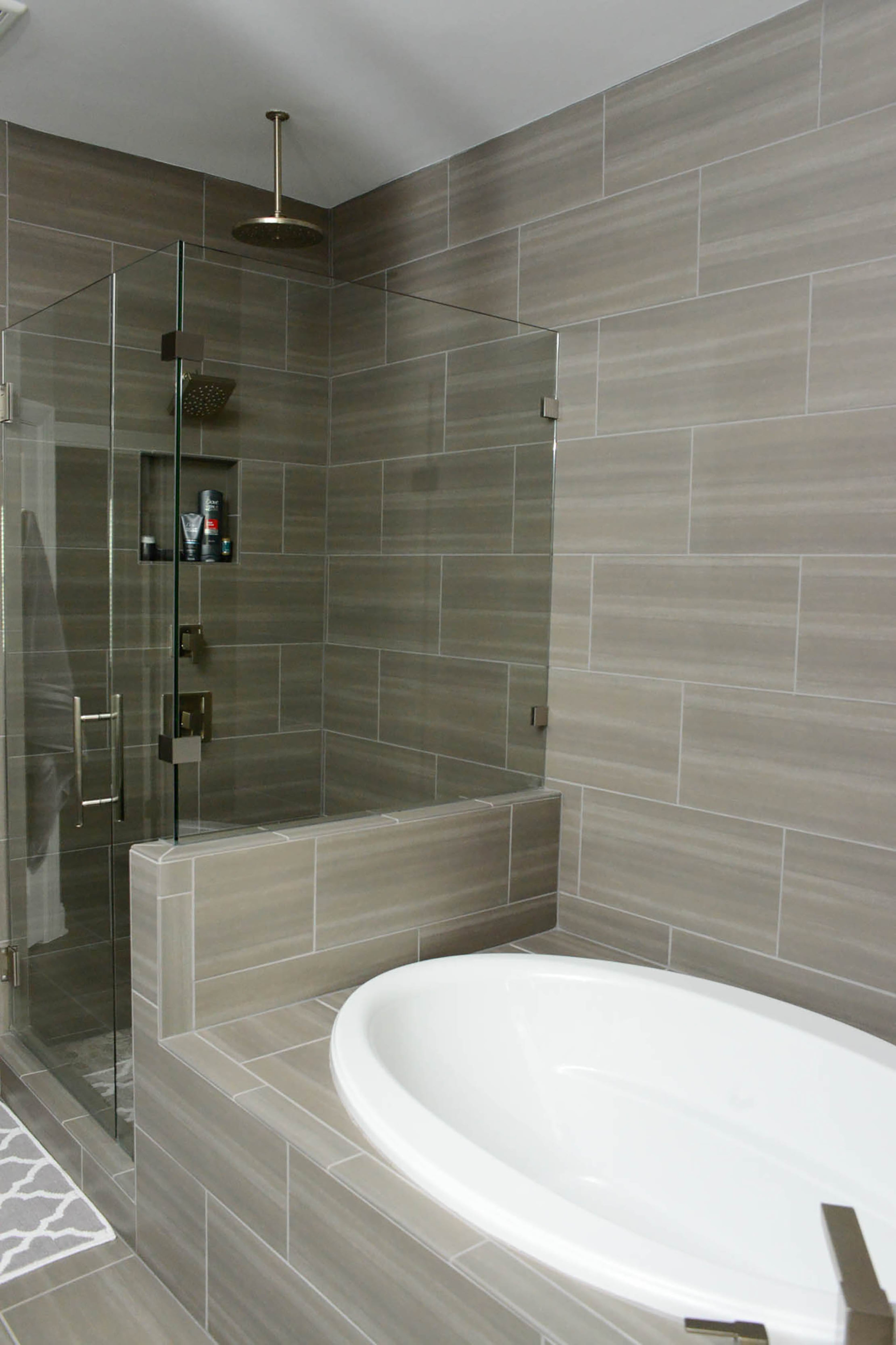 In the master bath, Dalusky tiled around the shower and bathtub to the ceiling to make the room feel taller. "I love the tile work in this space," Dalusky said. "We combined glass tile with natural stone for a spa-like feel." The townhome was built in 2017.