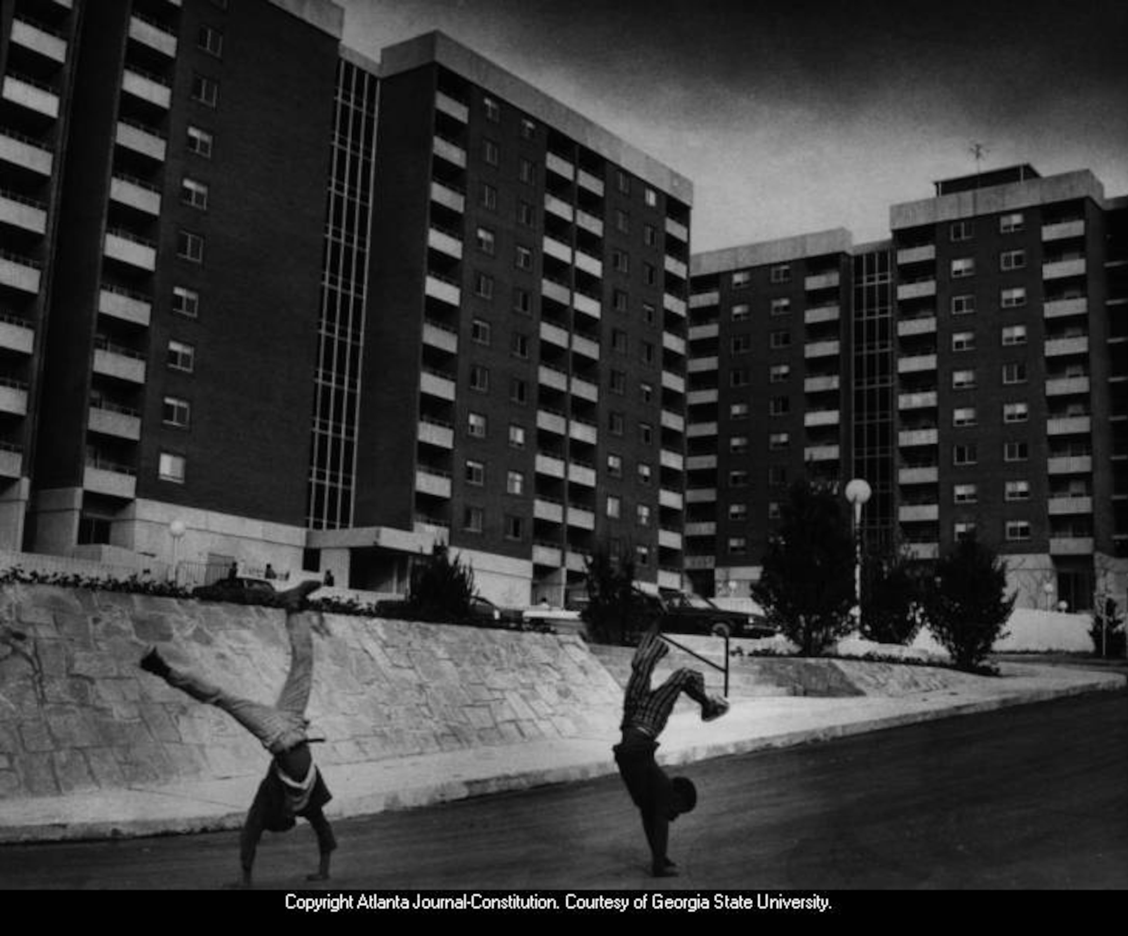 Dec. 1972 -- Two boys do cartwheels outside the Cosby Spear Memorial Towers public housing complex in Atlanta. BILL GRIMES / AJC PHOTO ARCHIVES