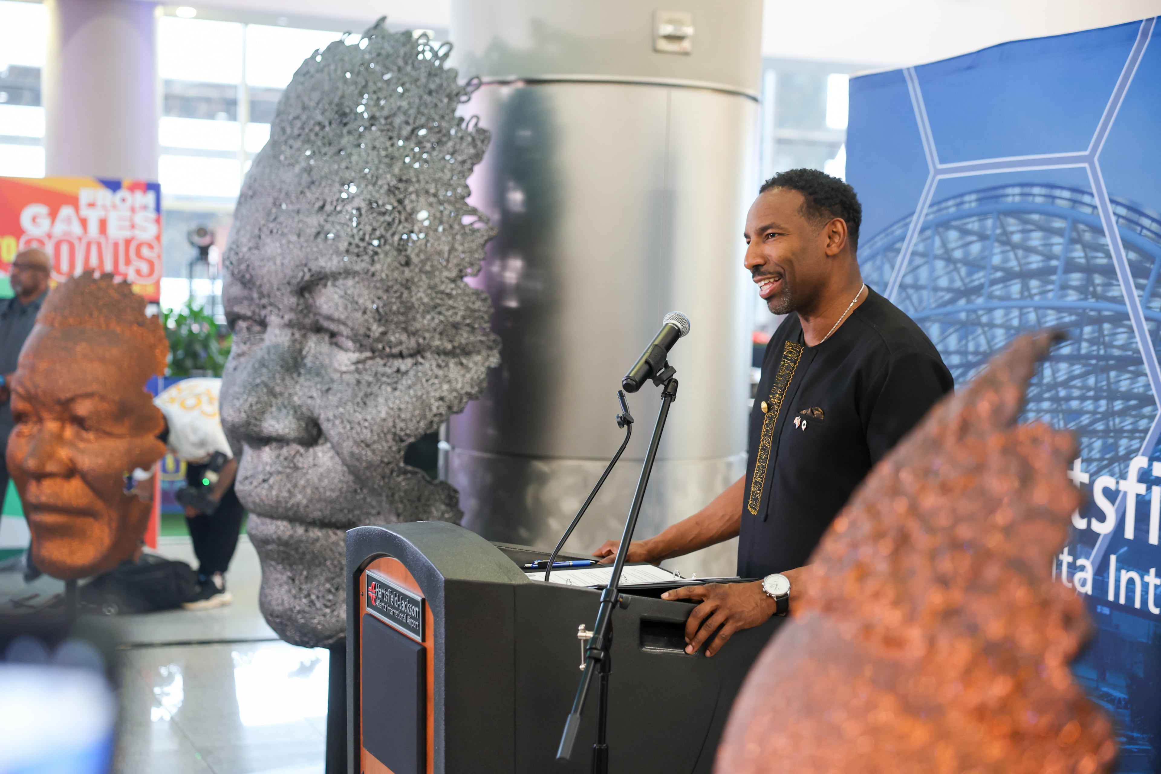 Atlanta Mayor Andre Dickens speaks at a ceremony unveiling a Nelson Mandela sculpture in the international terminal at Hartsfield-Jackson Atlanta International Airport on Wednesday, May 27, 2026. The sculpture was gifted to the city during Dickens’ visit to South Africa in 2024. (Arvin Temkar/AJC)