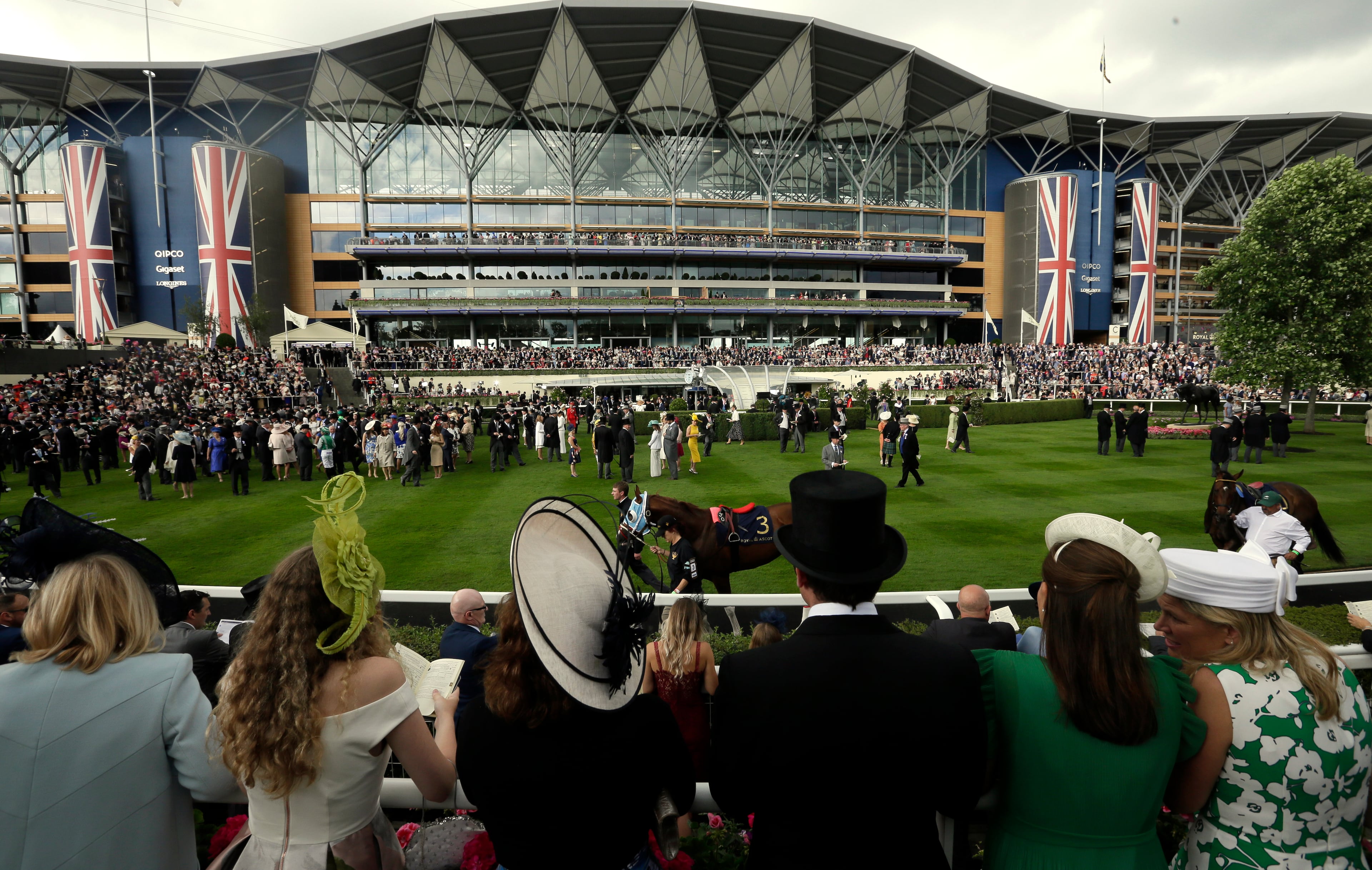 Racegoers watch the action on the first day of the Royal Ascot horse race meeting in Ascot, England, Tuesday, June 19, 2018. (AP Photo/Tim Ireland)