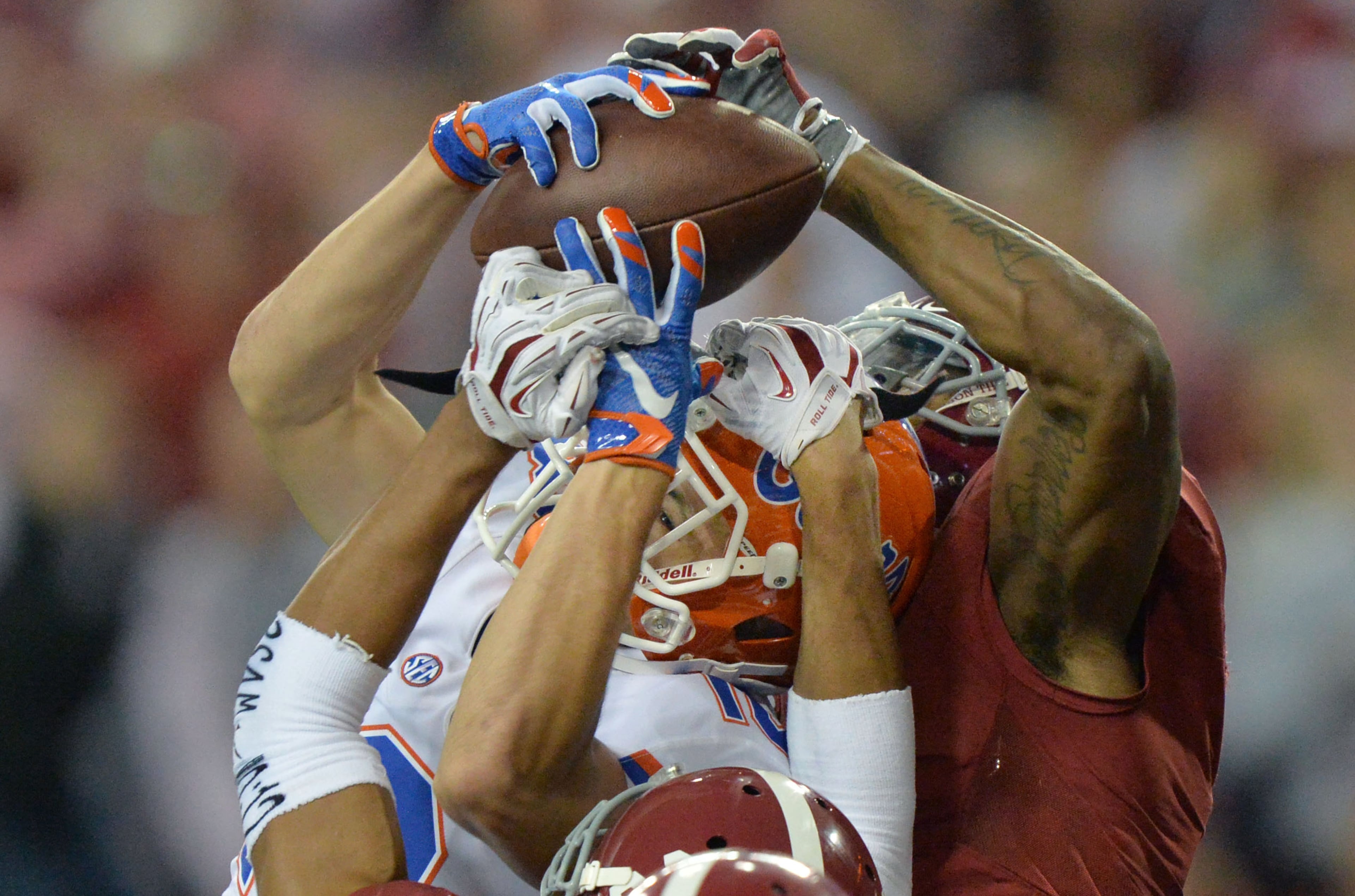 December 5, 2015 Atlanta - Florida Gators wide receiver C.J. Worton (18) catches a touchdown pass under pressure from Alabama Crimson Tide defensive back Minkah Fitzpatrick (29) and Alabama Crimson Tide defensive back Cyrus Jones (right) during Alabama's 29 - 15 win over Florida in the 2015 SEC Championship at the Georgia Dome on Saturday December 5, 2015. HYOSUB SHIN / HSHIN@AJC.COM