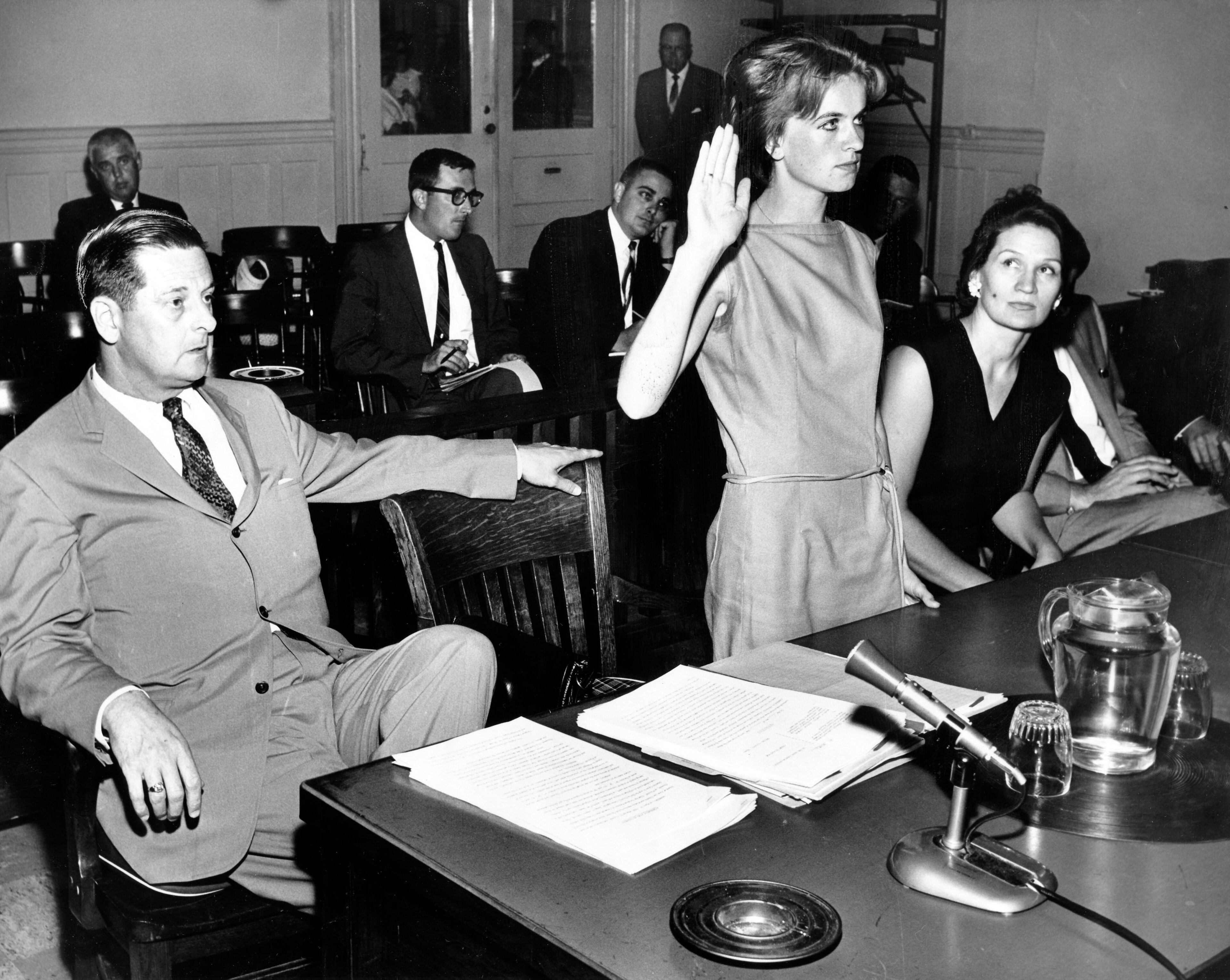 Mrs. Marina Oswald takes the oath of office from Judge Dee Brown Walker before testifying in the settlement of the contractual controversy with her former attorneys and business manager. At left is William A. McKenzie; to the right of Mrs. Oswald is Mrs. Declan Ford, her adviser and friend. (Bill Winfrey/Dallas Morning News, file/MCT)