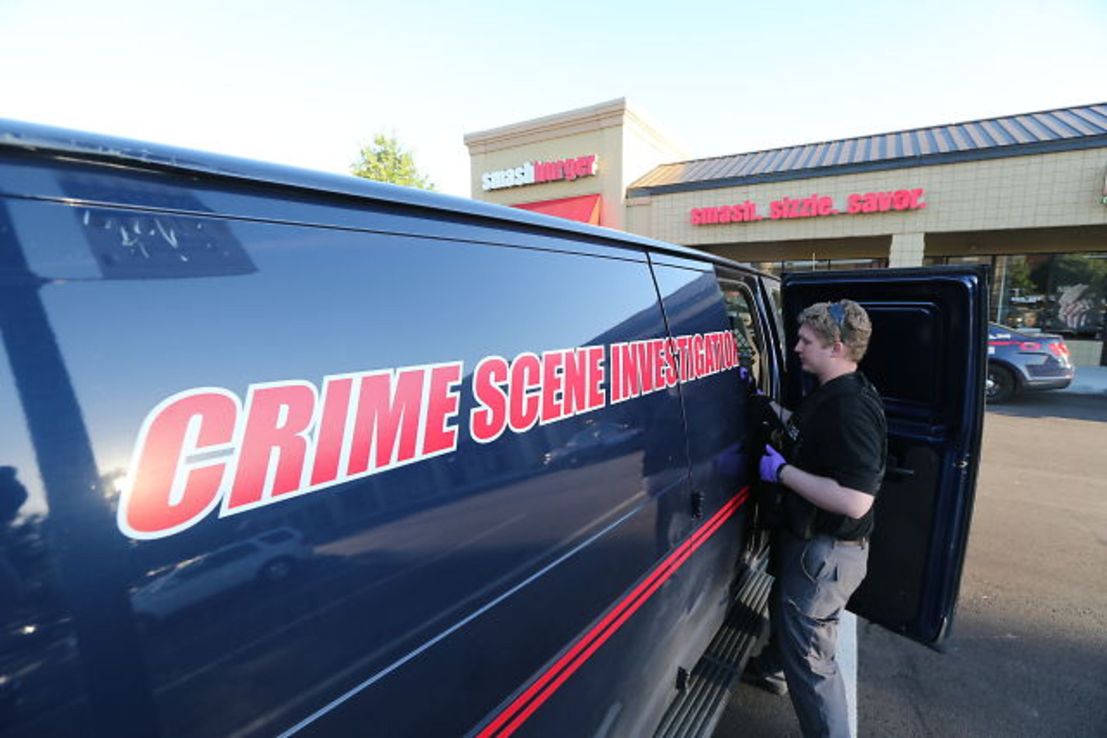 Smash-and-grab burglars hit the Smashburger restaurant and the Classic Touch Cleaners at the Buckhead Crossing shopping center just before daybreak Tuesday. JOHN SPINK / JSPINK@AJC.COM