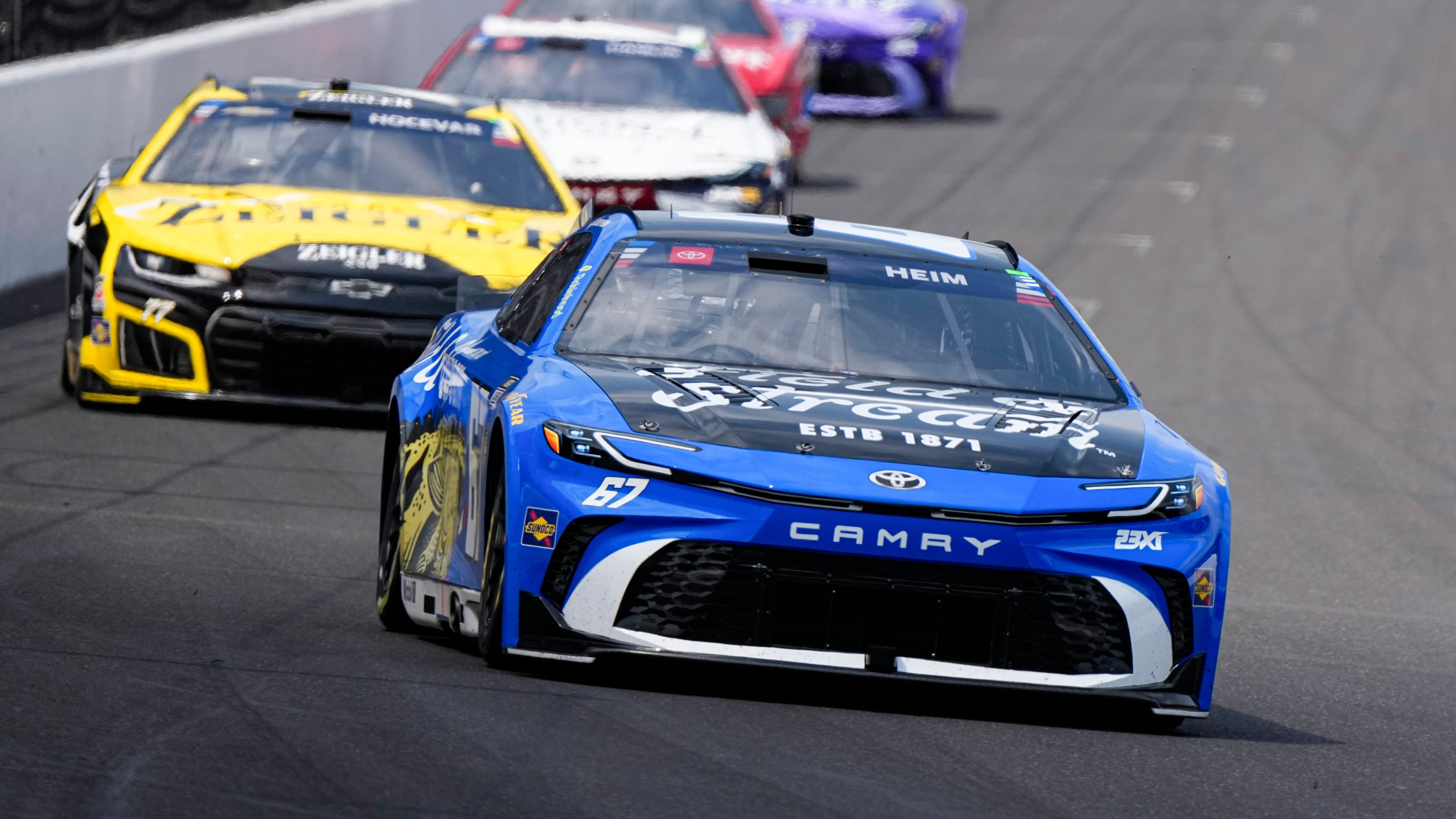 Corey Heim heads into the first turn during the NASCAR Cup Series auto race at Indianapolis Motor Speedway in Indianapolis, Sunday, July 26, 2026. (AP Photo/Michael Conroy)