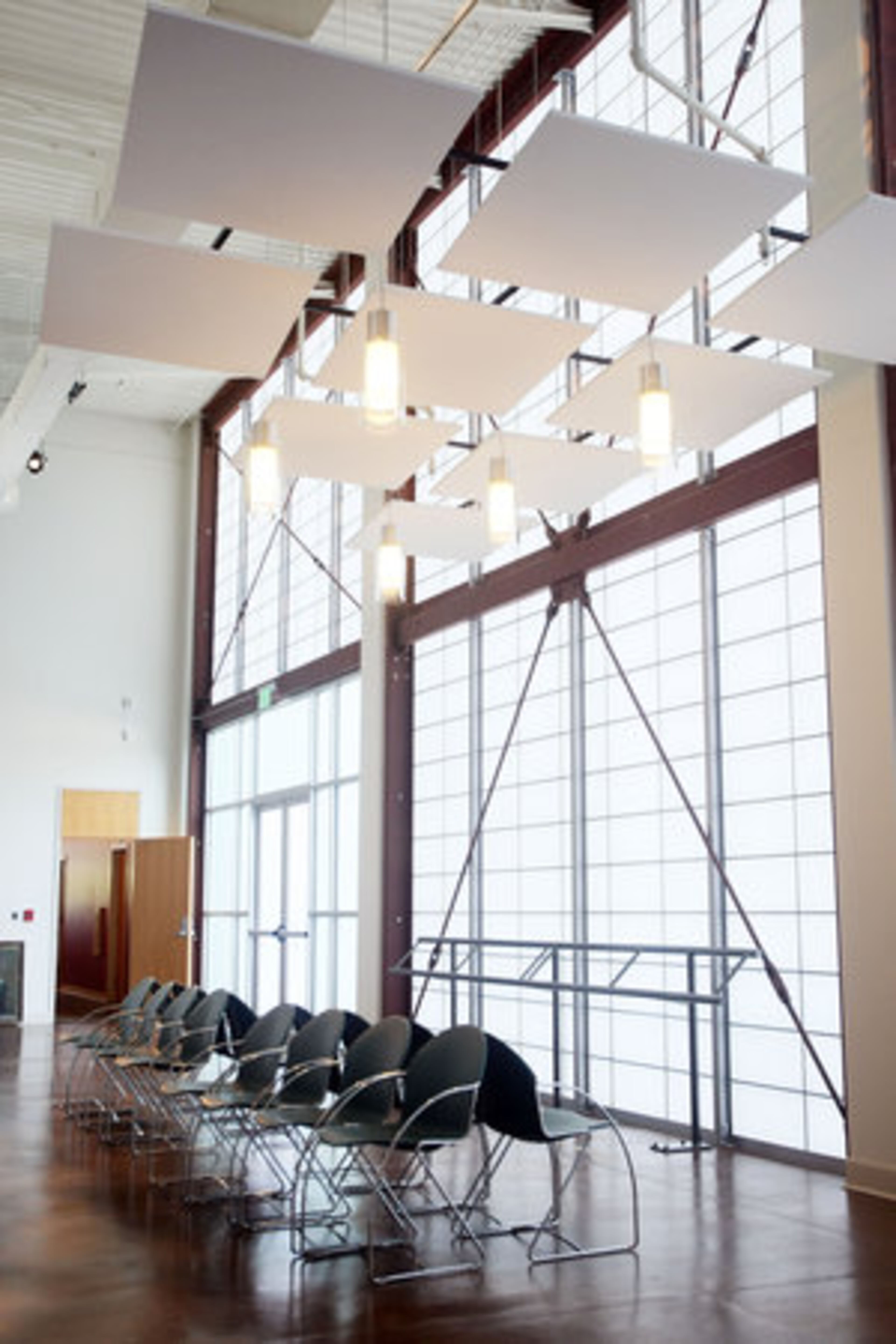 A sitting area placed near a wall constructed of Kalwall, a translucent paneling system that is well-insulated but allows sunlight to stream through.
