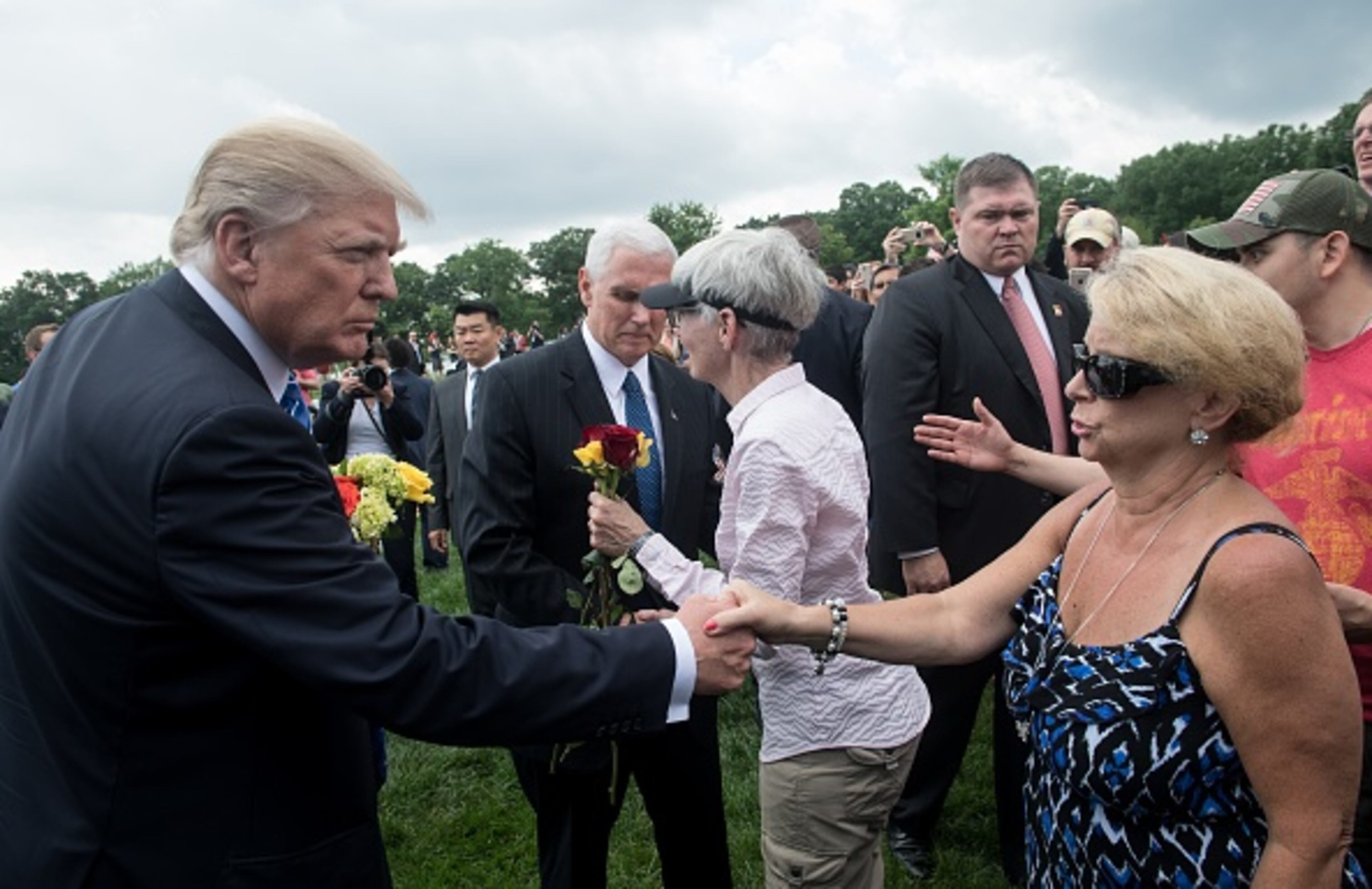 US President Donald Trump shakes hands with a woman as he visits Section 60 at Arlington National Cemetery to mark Memorial Day in Arlington, Virginia, on May 29, 2017. / AFP PHOTO / NICHOLAS KAMM (Photo credit should read NICHOLAS KAMM/AFP/Getty Images)
