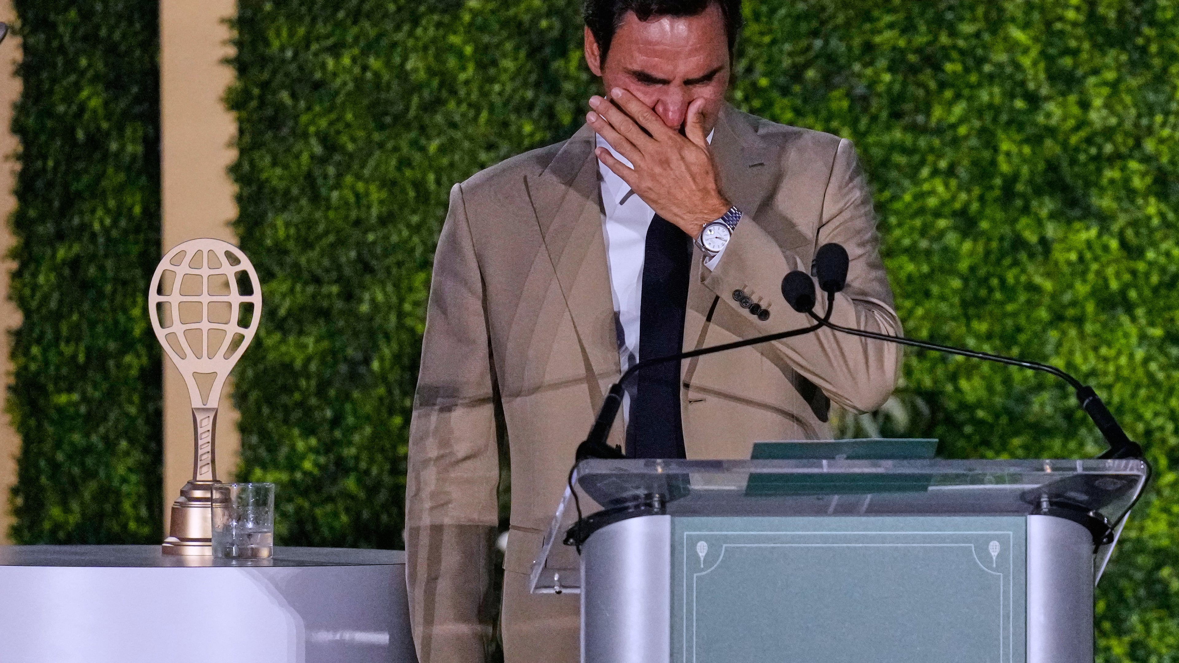 Roger Federer tries to hold back his tears during his induction ceremony at the International Tennis Hall of Fame, Saturday, Aug. 29, 2026, in Newport, R.I. (AP Photo/Charles Krupa)