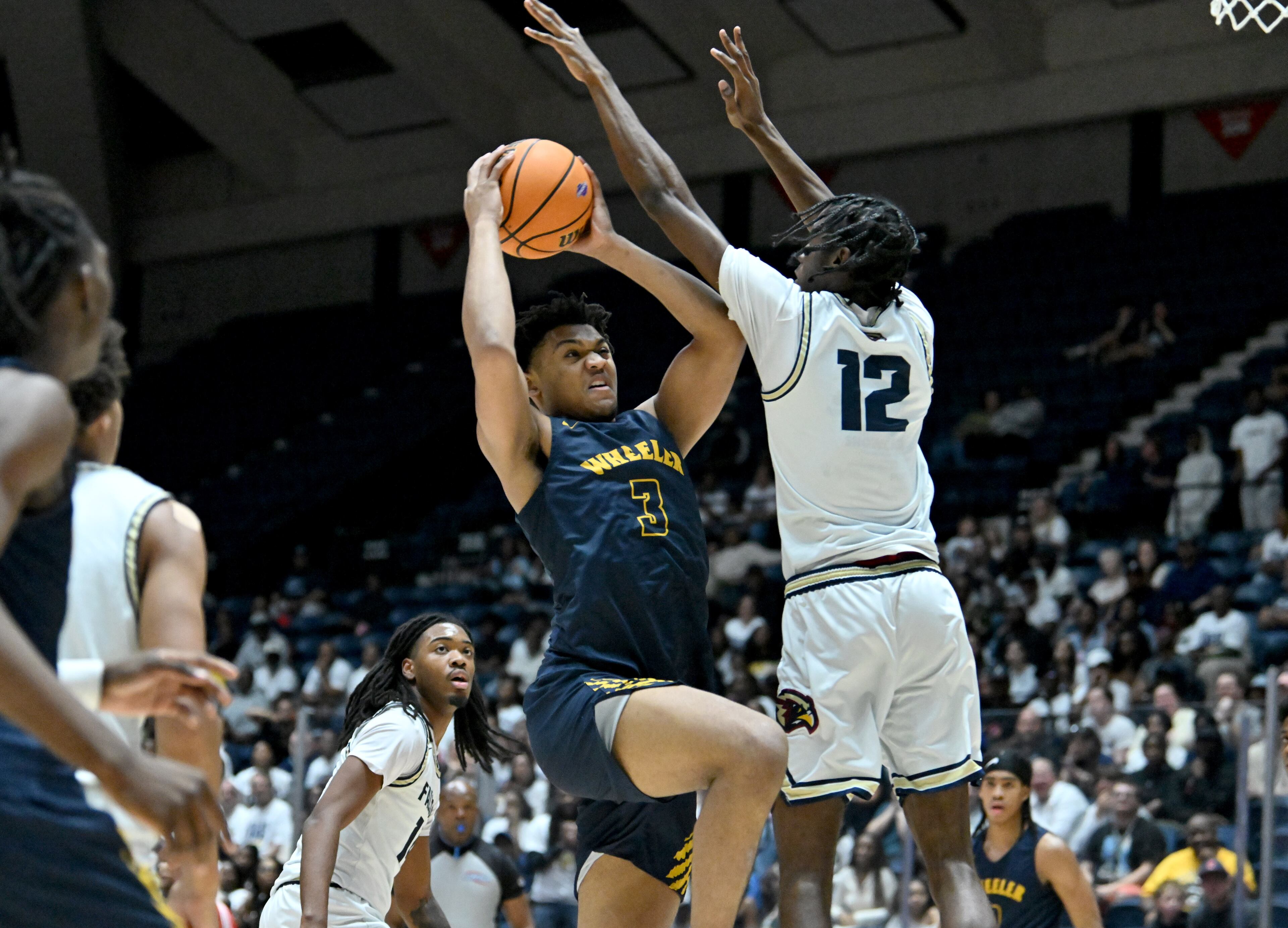 Wheeler Colben Landrew (3) drives to the basket against Pebblebrook Anthony Moon (12) during the first half in Class 6A Boys GHSA State Championship at the Macon Coliseum, Saturday, March 14, 2026, in Macon. Wheeler won 62-52 over Pebblebrook. (Hyosub Shin/AJC)