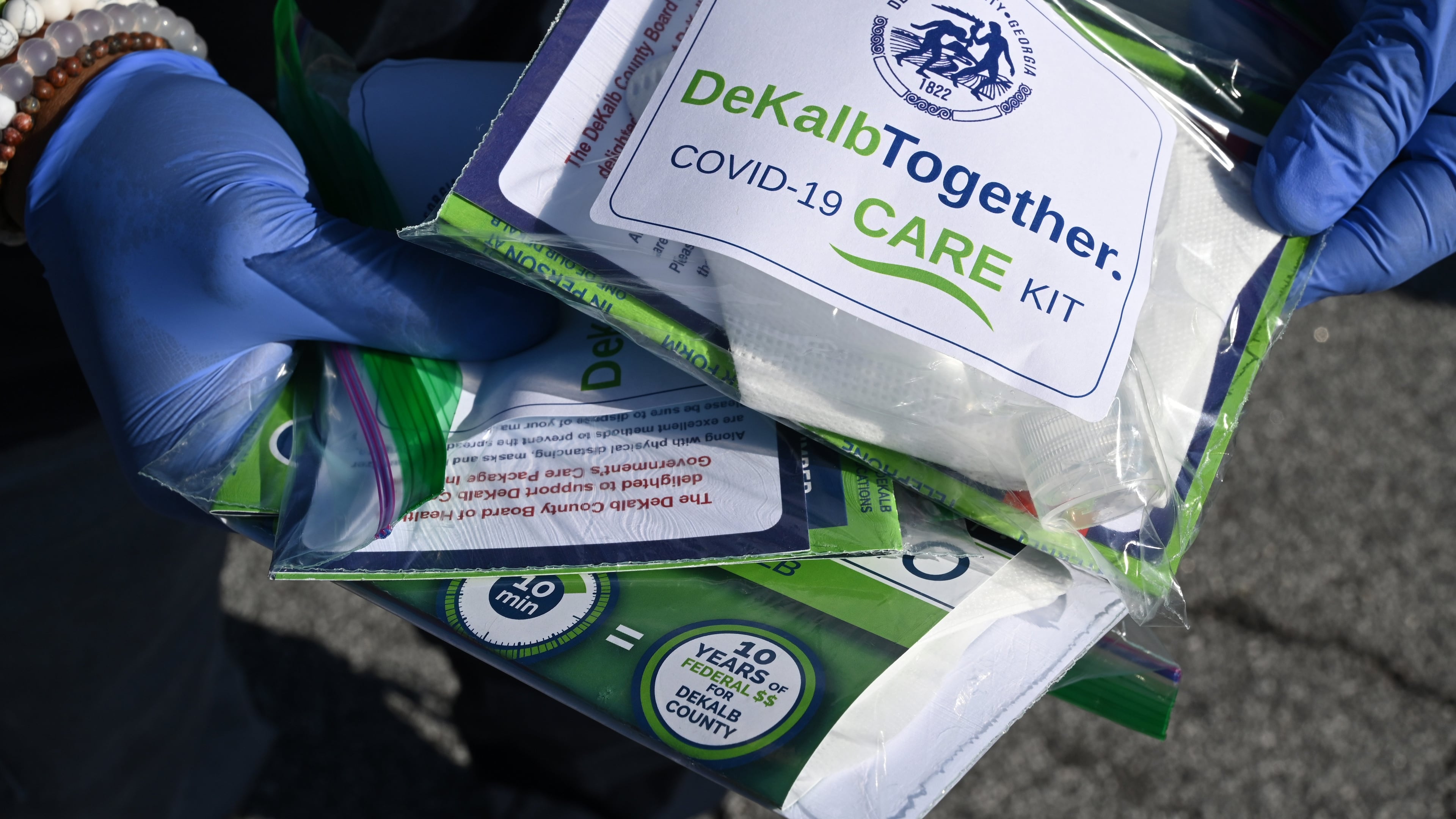 May 9, 2020 Decatur - DeKalb County police and fire cadets passed out COVID-19 care kits containing two non-surgical masks and hand sanitizer to residents to mitigate the spread of COVID-19 at Big Lots parking lot at 2738 Candler Road in Decatur on Saturday, May 9, 2020. DeKalb County Board of Health is supporting this initiative. (Hyosub Shin / Hyosub.Shin@ajc.com)