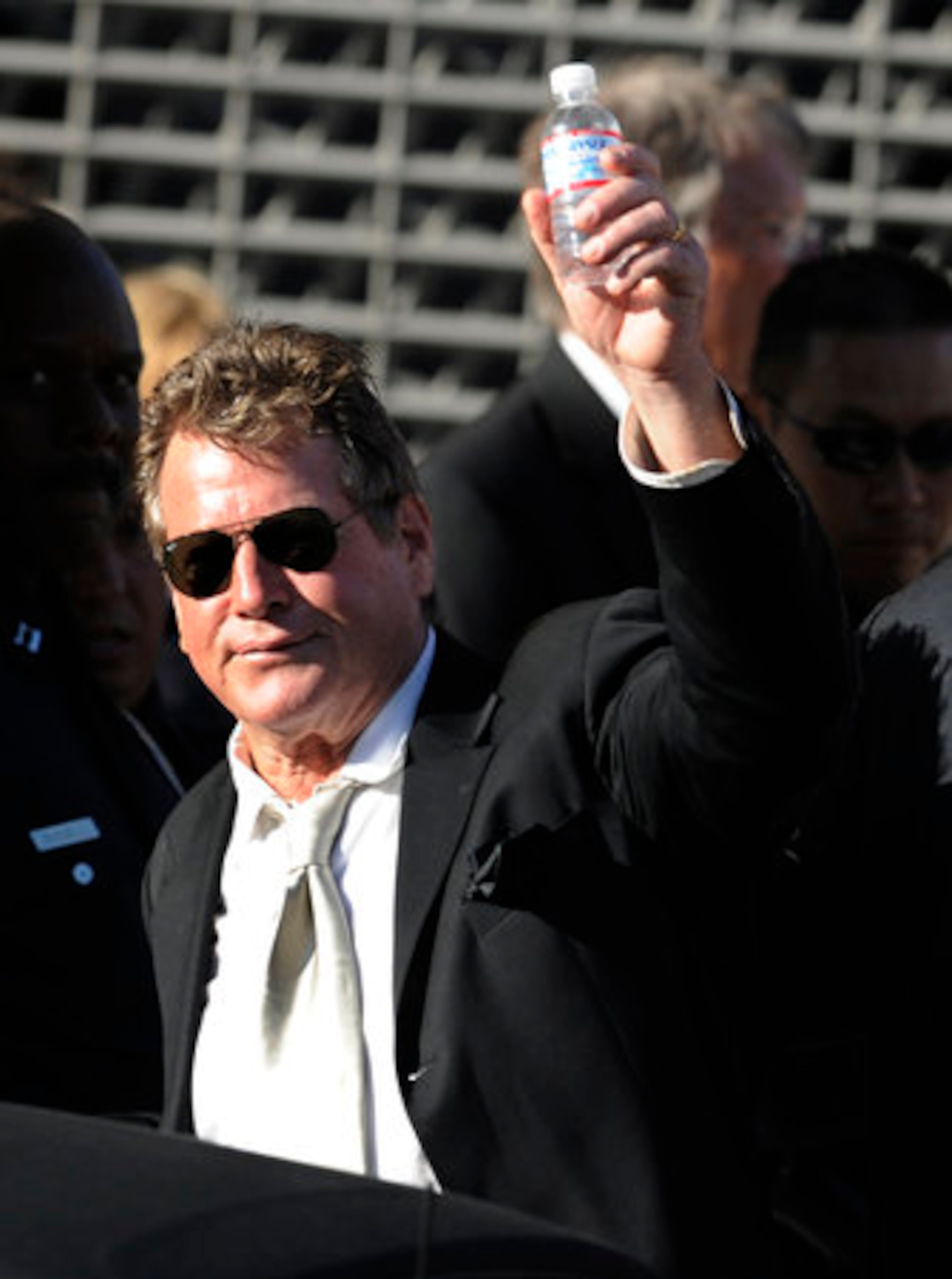 Ryan O'Neal waves to a crowd outside the funeral.l