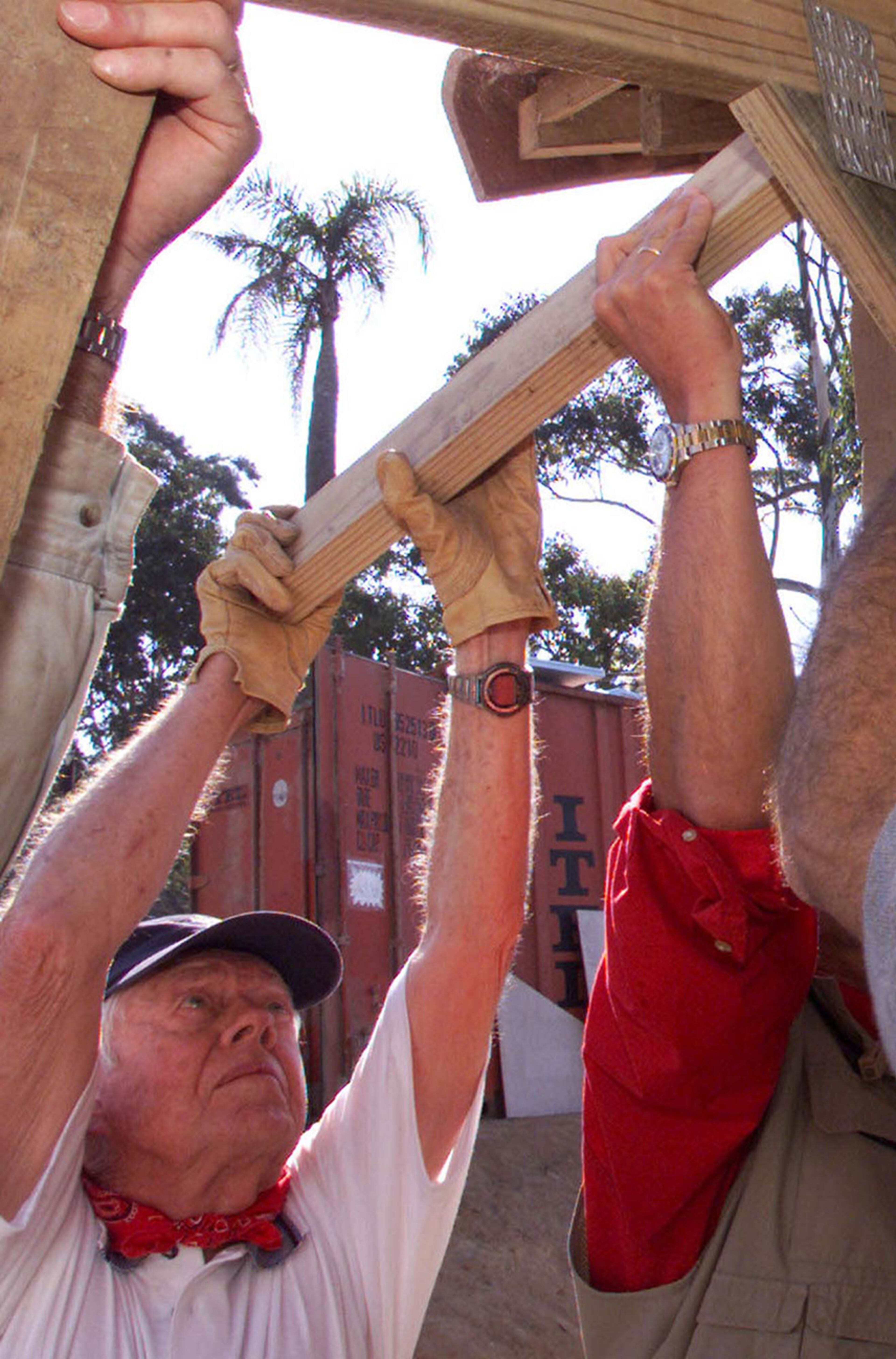 2002 (Durban, South Africa): Former U.S. President Jimmy Carter helps in the construction of a low income housing project. Carter was among 4,500 volunteers who built 100 homes that week. (THEMBA HADEBE / AP file)