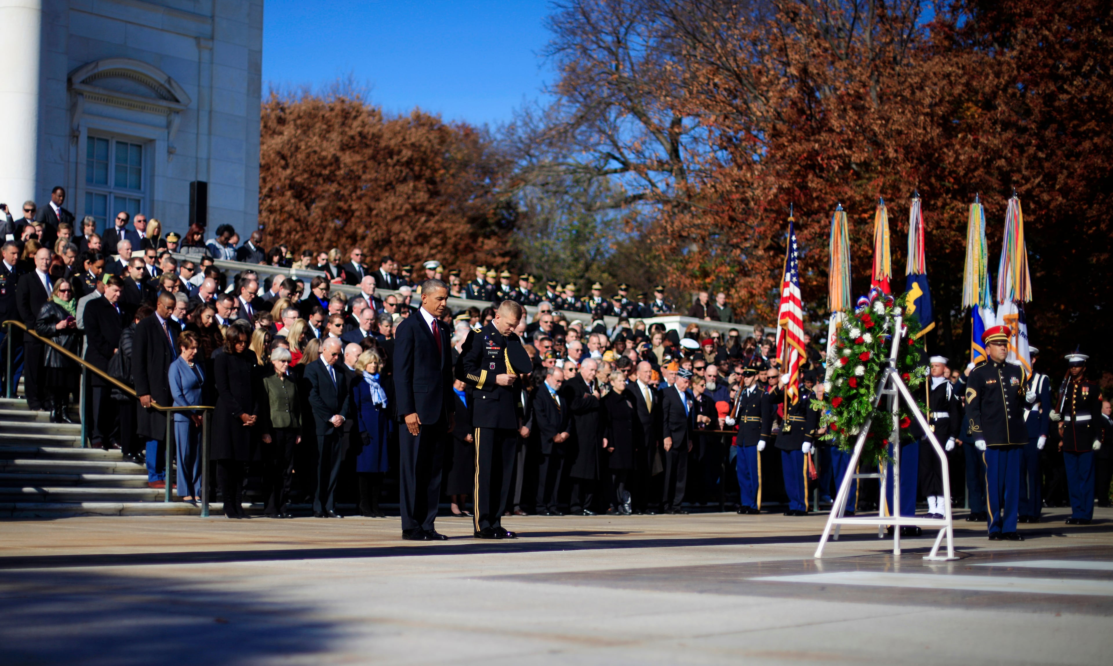 President Barack Obama and Maj. Gen. Jeffrey S. Buchanan, right, of the U.S. Army Military District of Washington, lower their heads after the president placed a wreath at the Tomb of the Unknowns, Monday, Nov. 11, 2013, at Arlington National Cemetery during a Veterans Day ceremony.