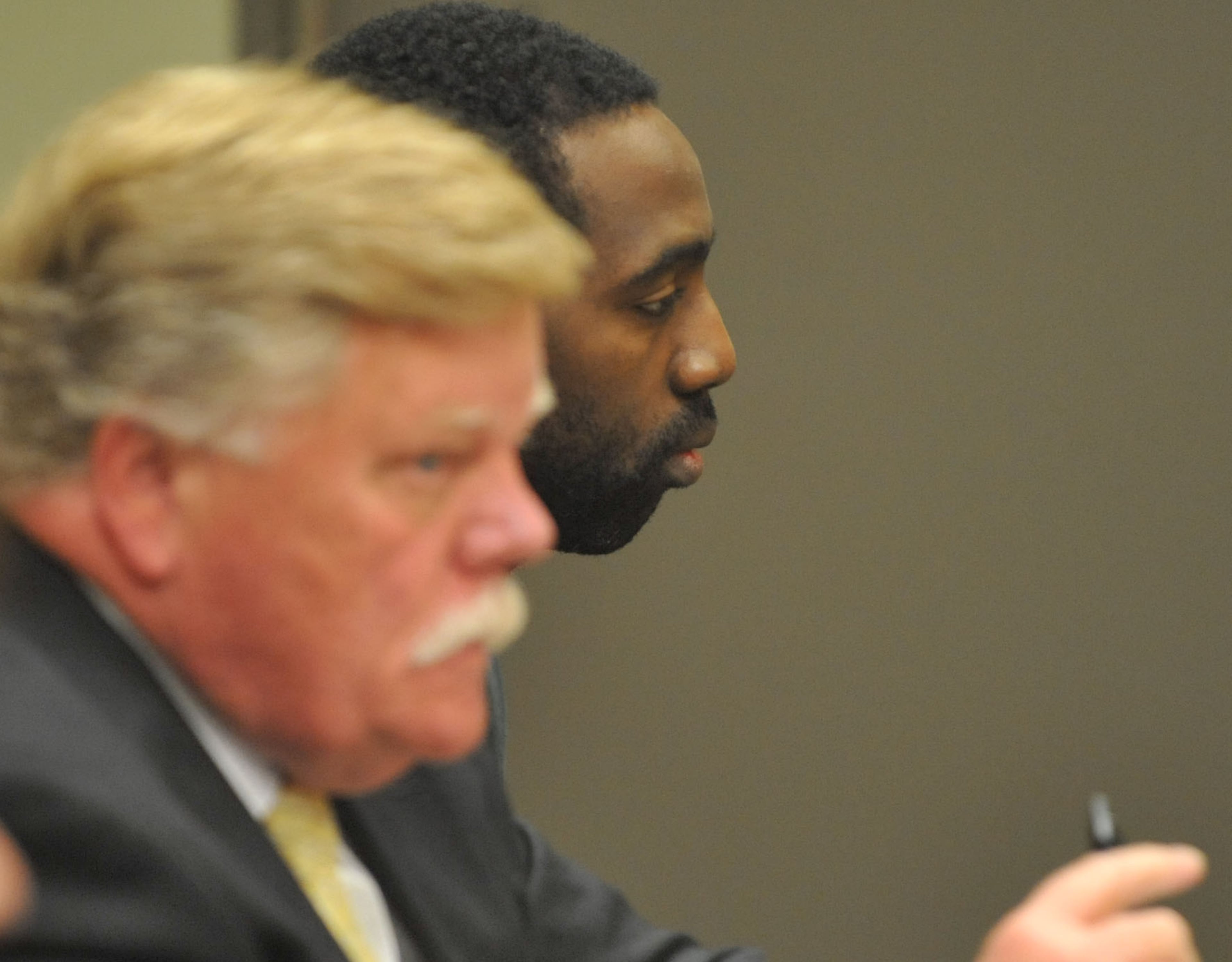 Eman Moss (right) sits with his attorney, John Burdgess in Magistrate Court Friday. Eman Moss said his wife and daughter had a “rocky relationship,” Flynn testified. Tiffany Moss was on probation for beating Emani with a belt in 2010.