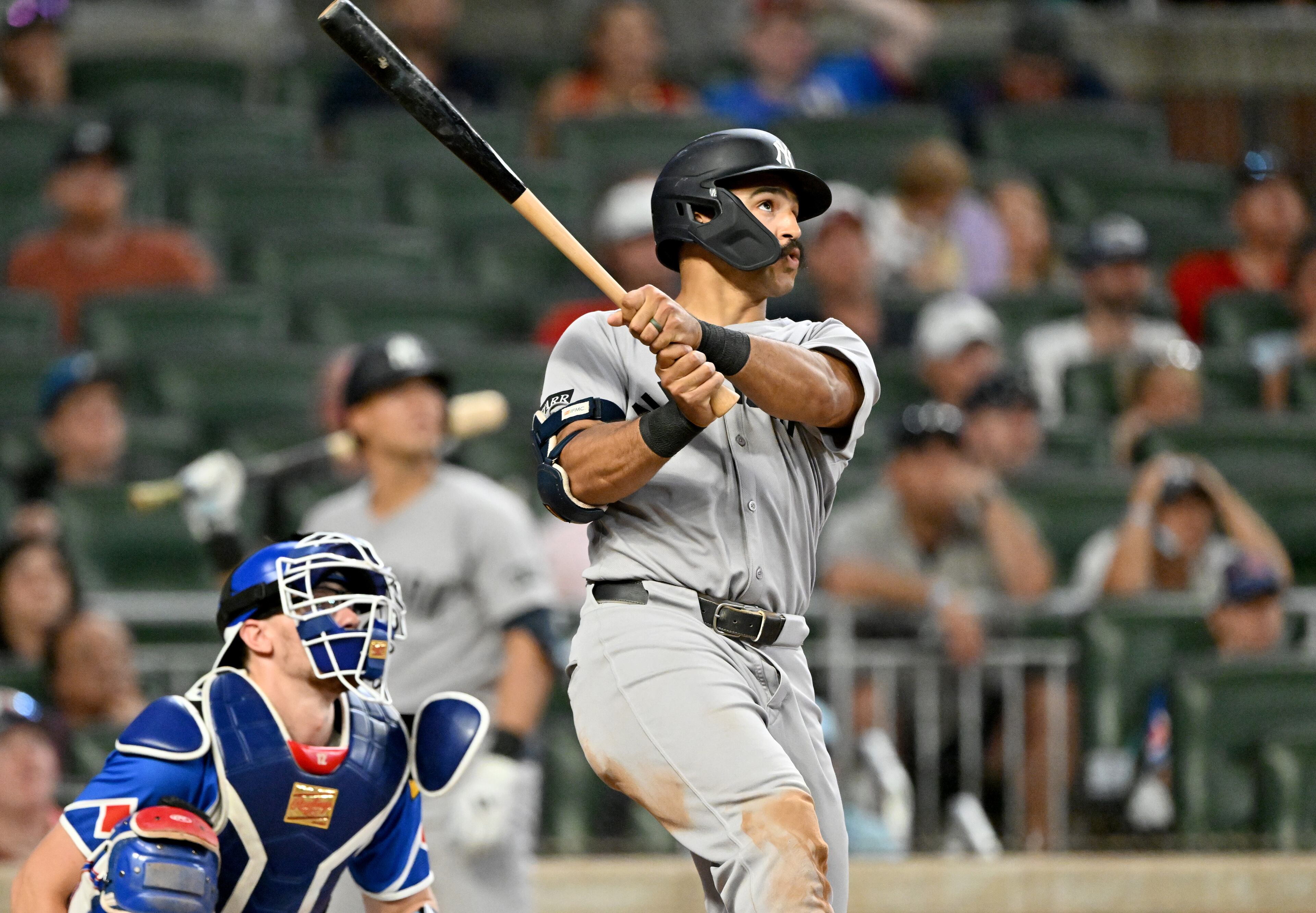 New York Yankees outfielder Trent Grisham (12) hits a grand slam during the ninth inning of a baseball game at Truist Park, Saturday, July 19, 2025, in Atlanta. New York Yankees won 12-9 over Atlanta Braves. (Hyosub Shin / AJC)