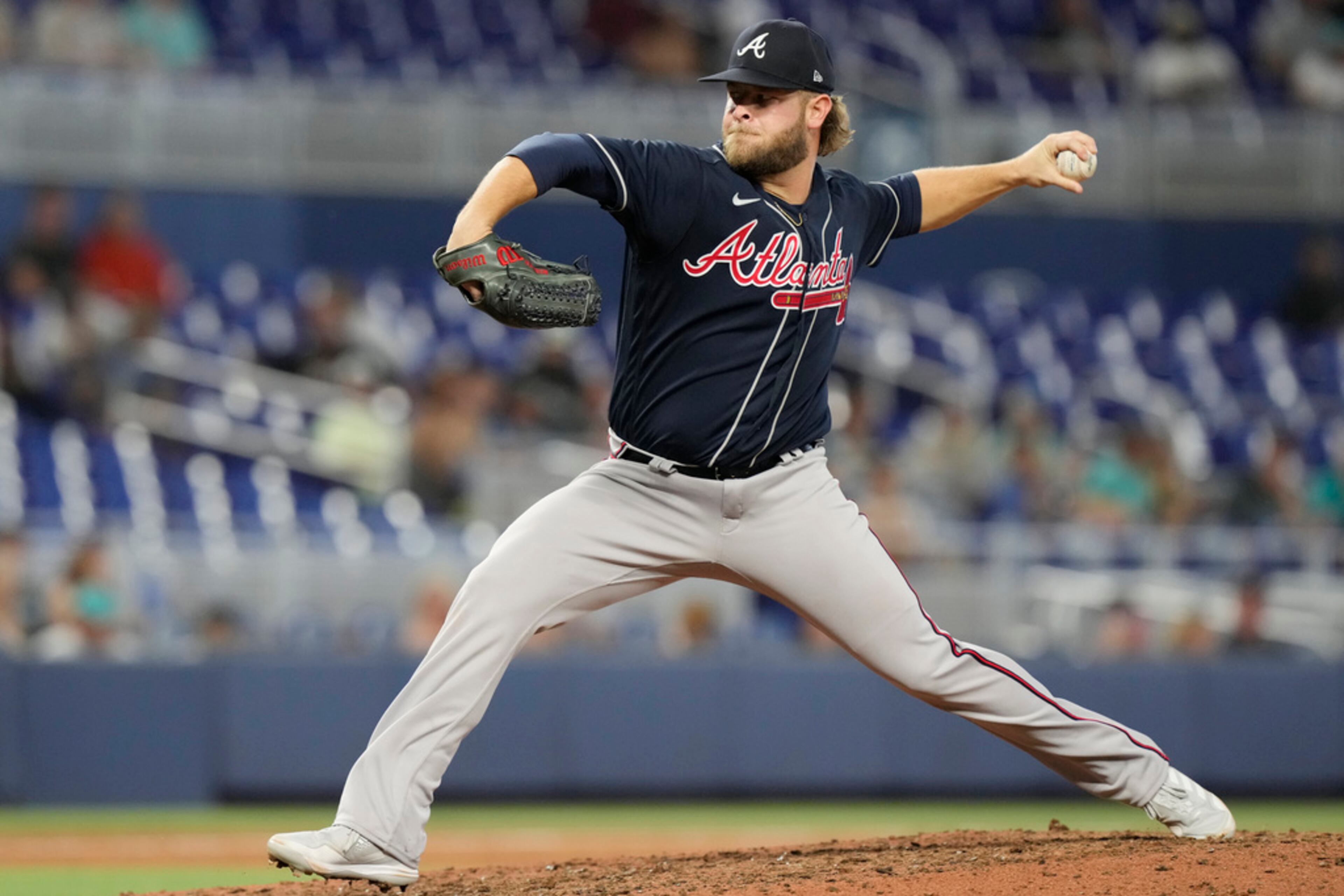Atlanta Braves relief pitcher A.J. Minter (33) aims a pitch during the ninth inning of a baseball game against the Miami Marlins, Thursday, May 4, 2023, in Miami. (AP Photo/Marta Lavandier)