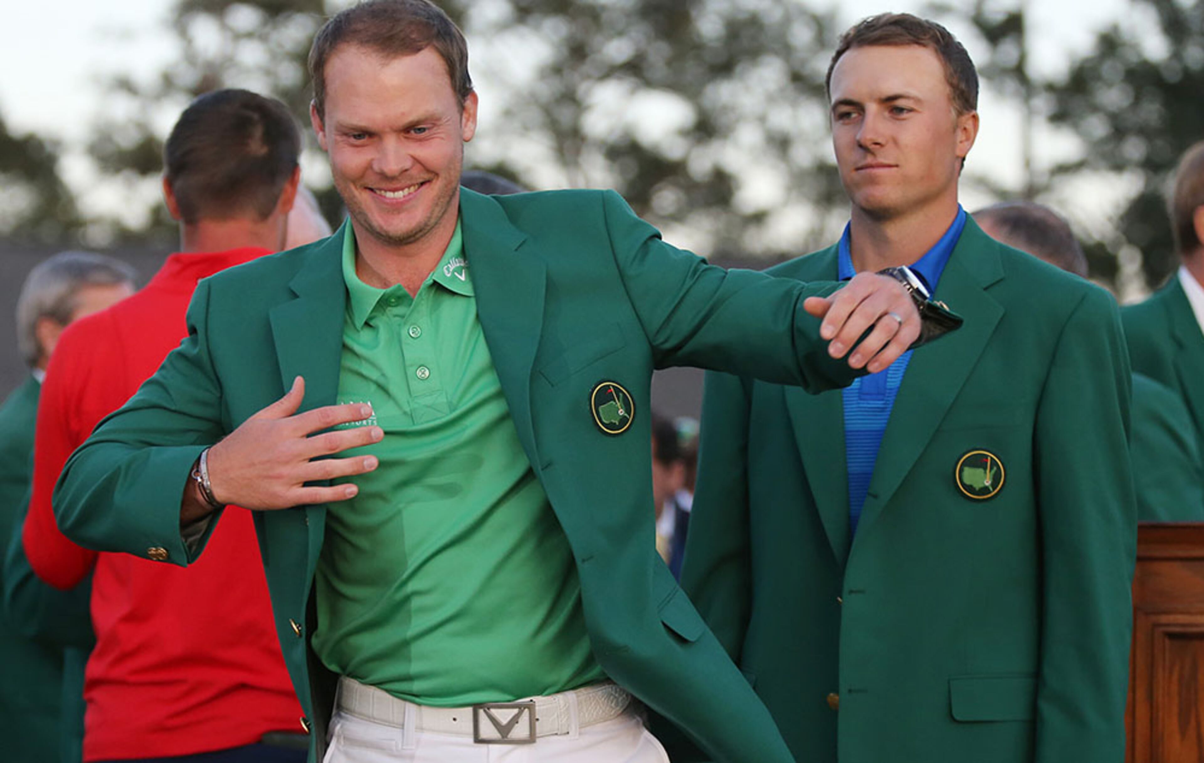 A somewhat dejected Jordan Spieth looks on presenting Danny Willett the green jacket for winning the Masters at Augusta National Golf Club on Sunday, April 10, 2016, in Augusta.