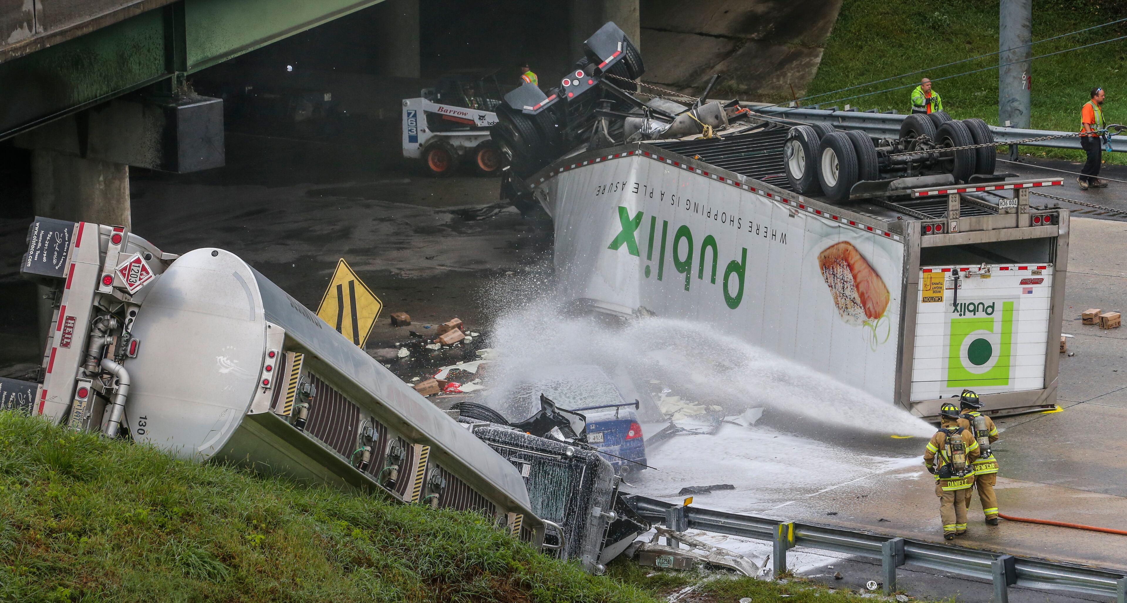 Driverless truck technology has the potential to minimize traffic calamities like this one, when two tractor-trailers plunged from I-285 and landed on Ga. 400 in 2015. JOHN SPINK /JSPINK@AJC.COM