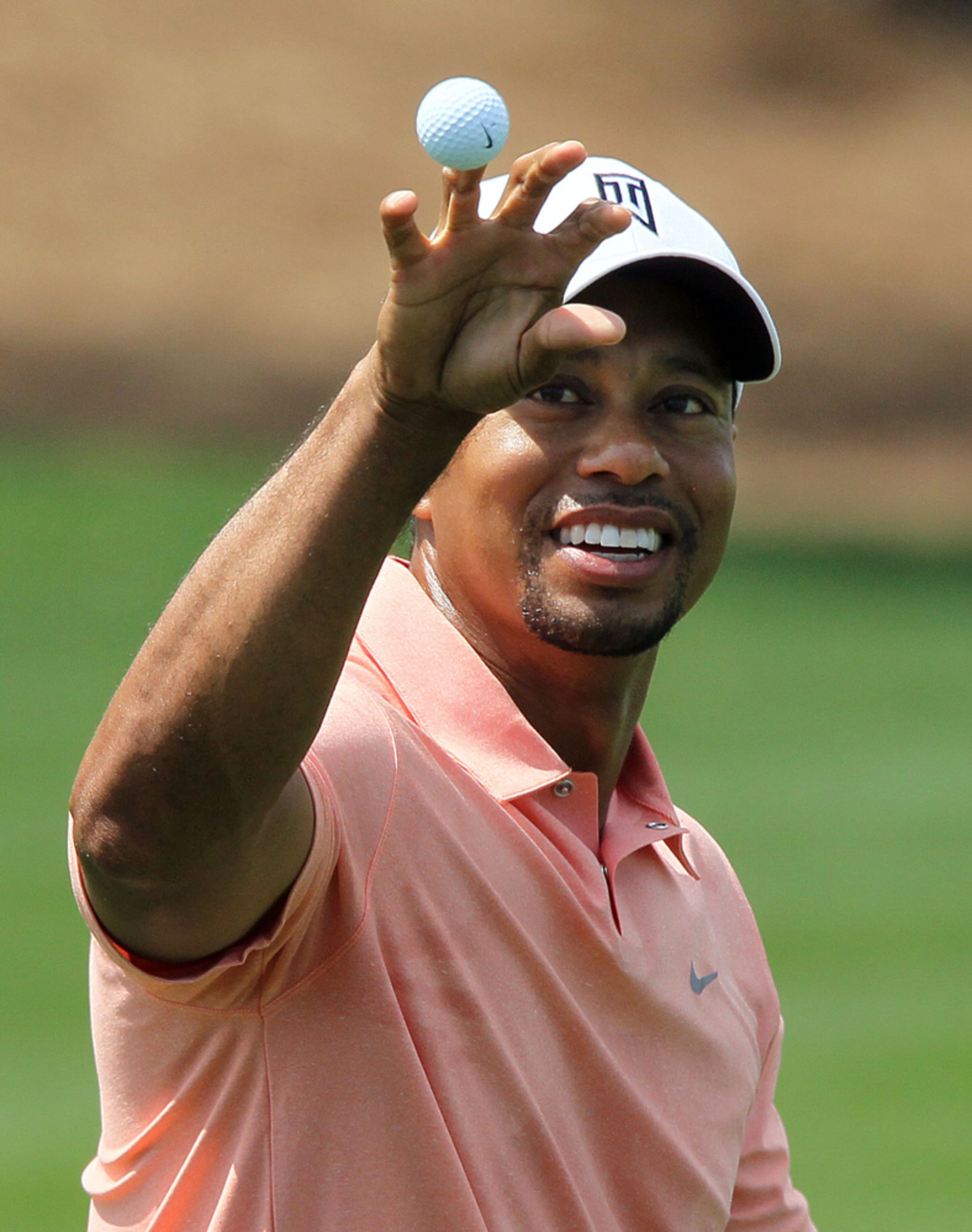APRIL 9, 2012-AUGUSTA: Tiger Woods catches a ball thrown by his caddie on the practice tees during the second day of practice rounds for the Masters Tournament at Augusta National Golf Club on Monday April 8th, 2013. PHIL SKINNER / PSKINNER@AJC.COM