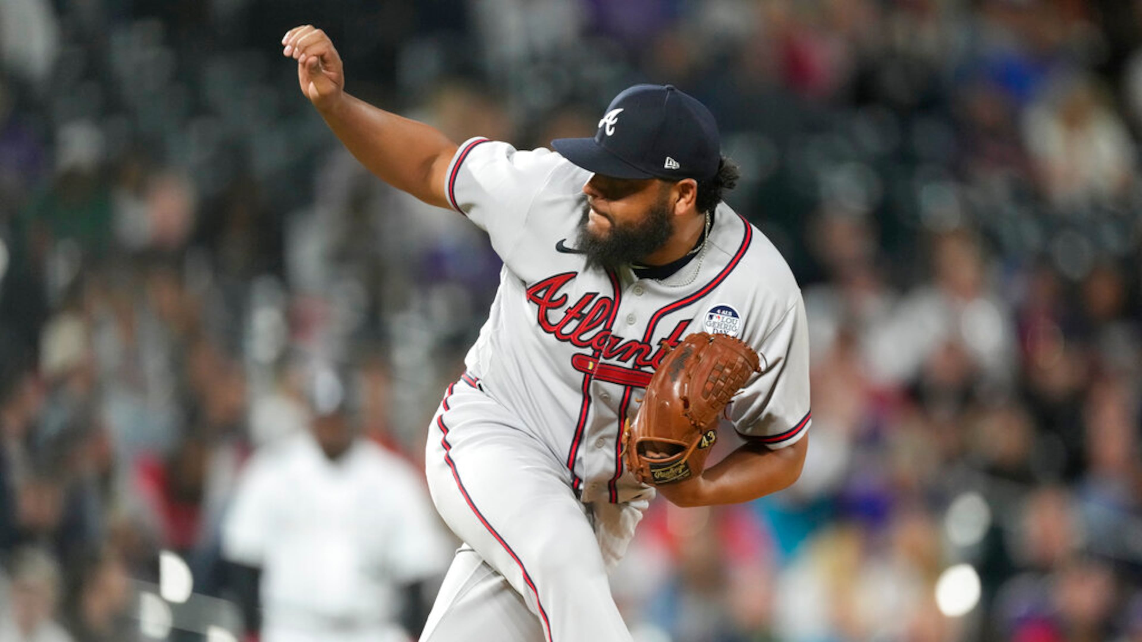 Atlanta Braves relief pitcher Jesus Cruz watches a delivery to a Colorado Rockies batter during the seventh inning of a baseball game Thursday, June 2, 2022, in Denver. (AP Photo/David Zalubowski)
