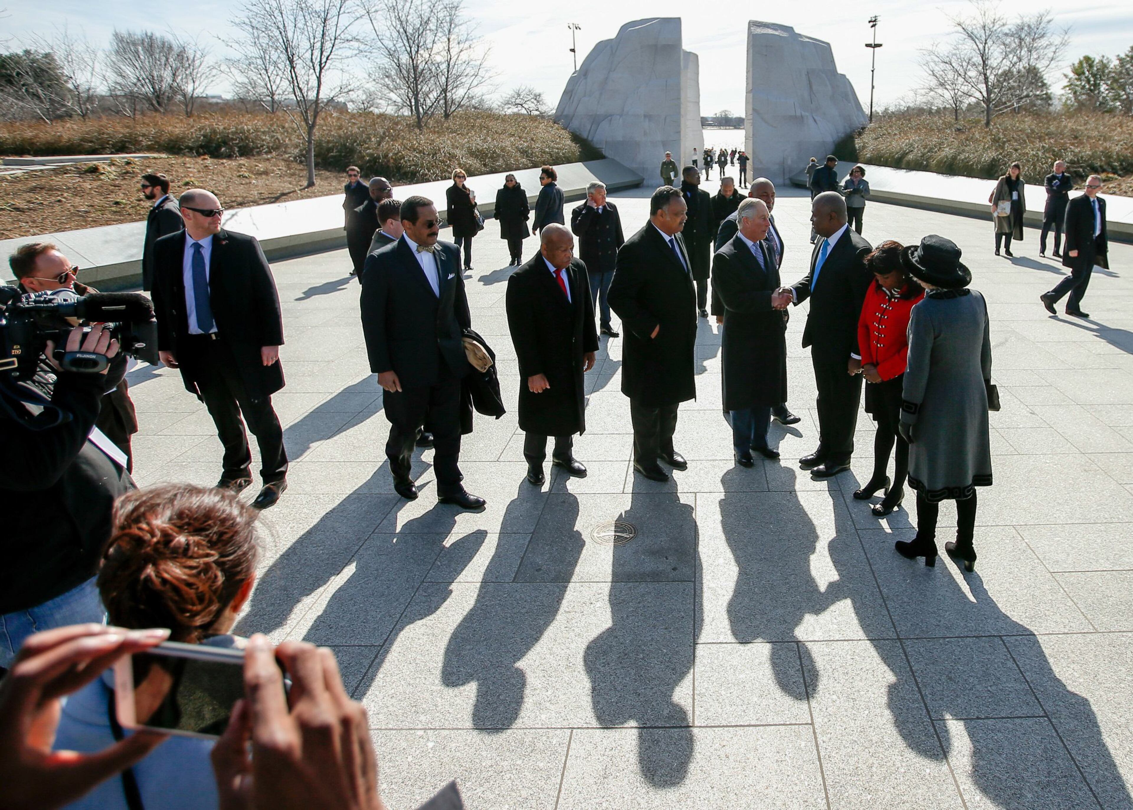 Britain's Prince Charles (4thR) and Camilla, the Duchess of Cornwall (R) tour the Martin Luther King, Jr. Memorial with President and CEO of the Martin Luther King, Jr. Memorial Project Foundation Harry Johnson (3rdR), Rev. Jesse Jackson (C), Rep. John Lewis, D-GA, (2ndL), Rep. Terri Sewell, (D-AL) (2ndR) and Dr. Ed Jackson (L), chief architect of the memorial, in Washington, March 18, 2015. The royal couple are visiting cultural and educational sites in the Washington region. REUTERS/Andrew Harnik/Pool