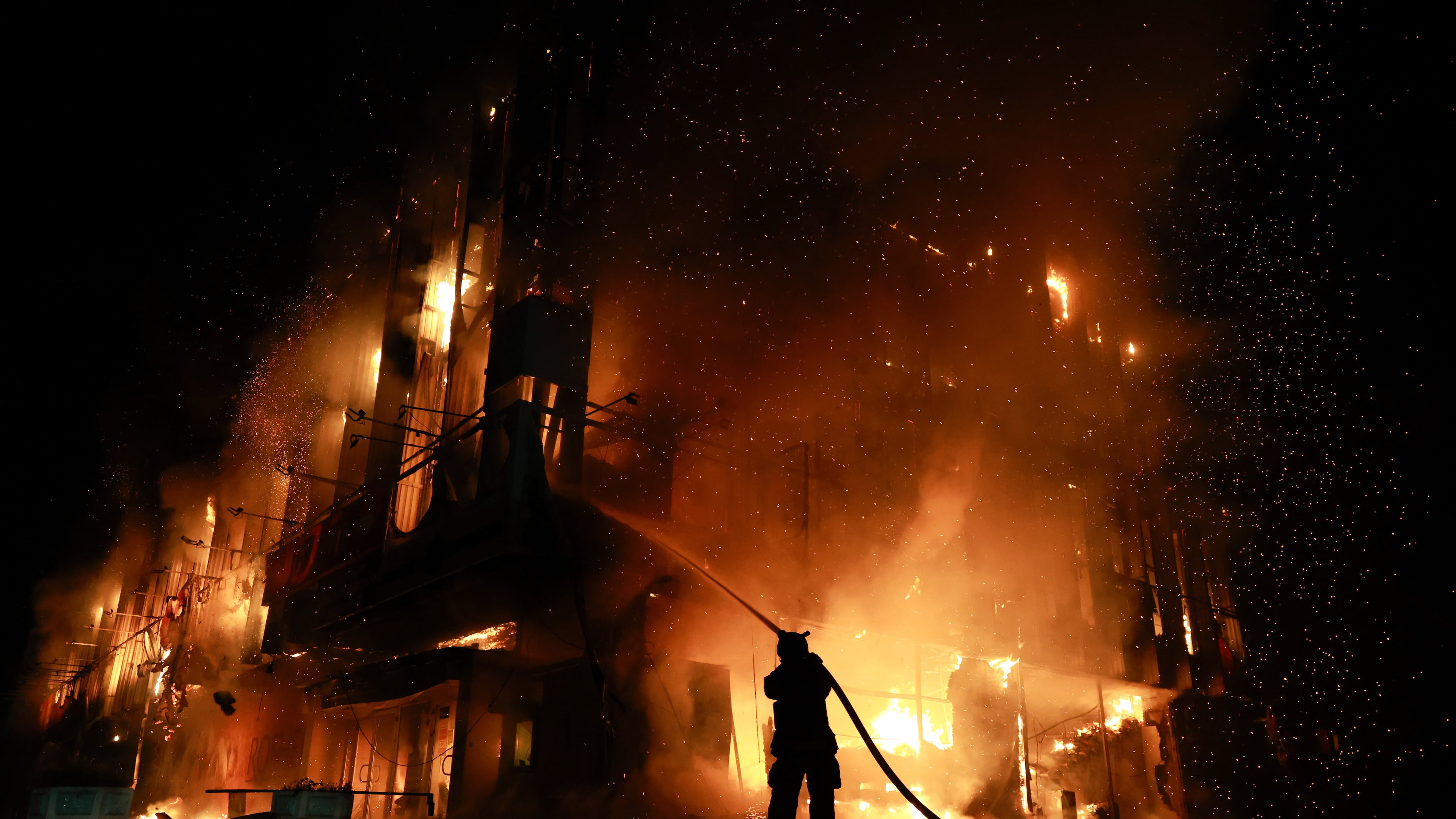 A rescue worker puts out a fire at the Intrade trade center after a Russian drone strike on Zaporizhzhia, Ukraine, Monday, Sept. 21, 2026. (AP Photo/Kateryna Klochko) Correction: Byline corrected to Kateryna Klochko, instead of Evgeniy Maloletka