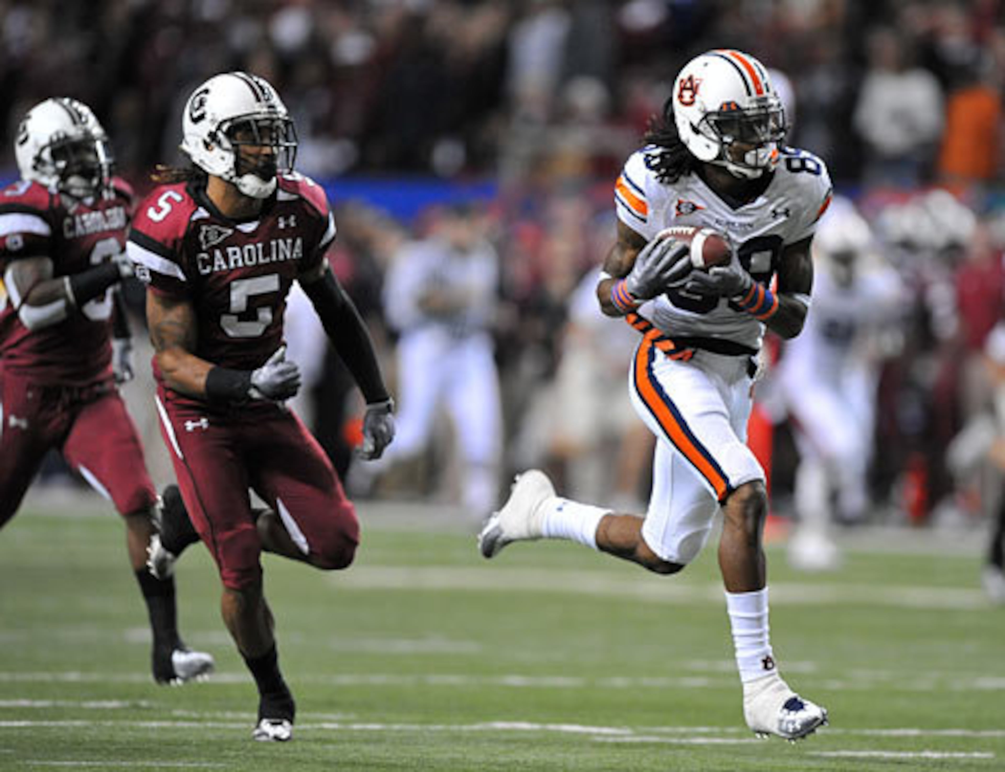 Auburn Tigers wide receiver Darvin Adams hauls in a 62-yard pass in front of South Carolina Gamecocks cornerback Stephon Gilmore (5) during the SEC Championship.